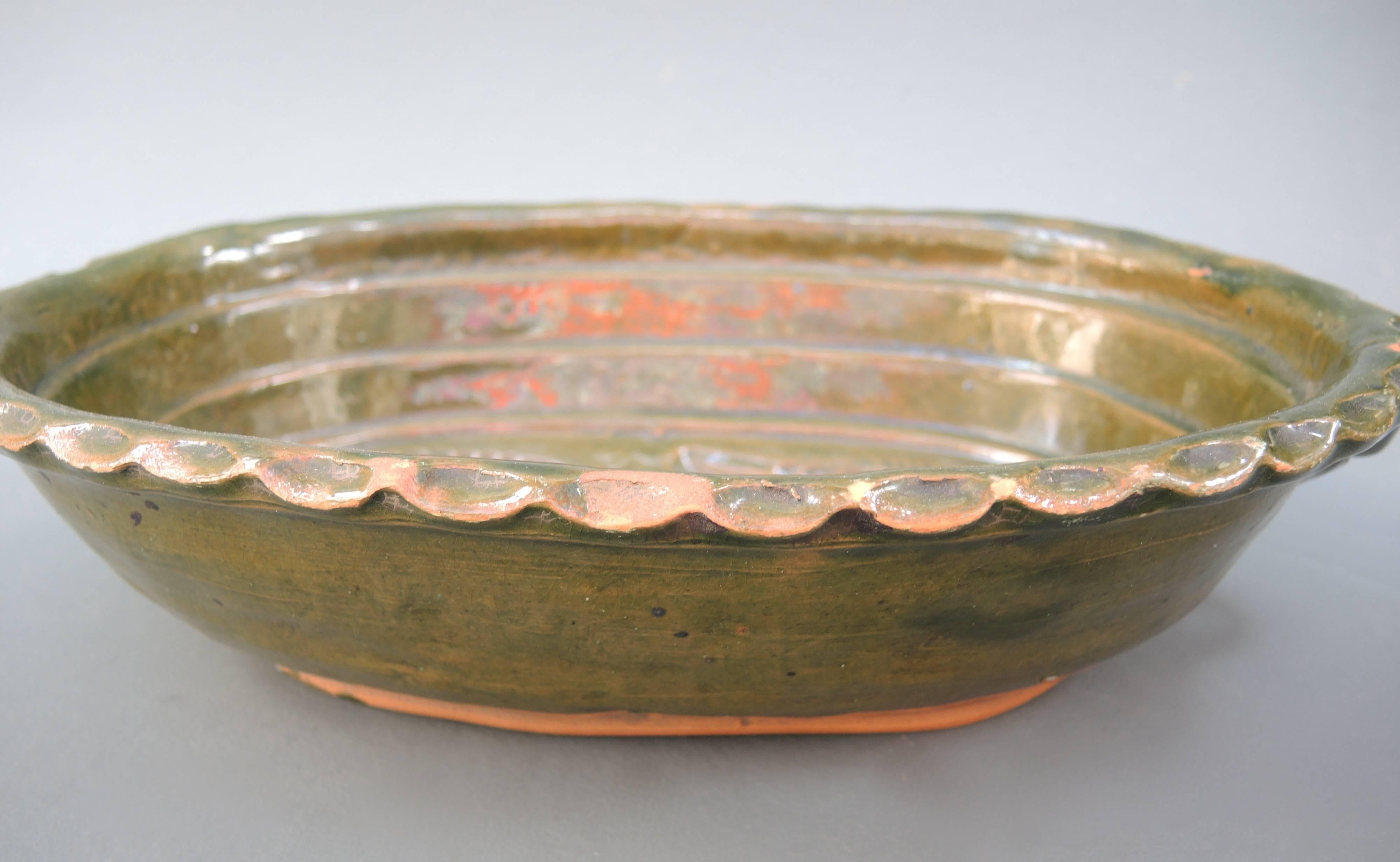 This mid-19th century French glazed terracotta baking dish is made with an impressed double fish design so that when the cake is removed the pair of fish appear as a raised design on the surface. Also used to make chilled mousse and gelatins.
 