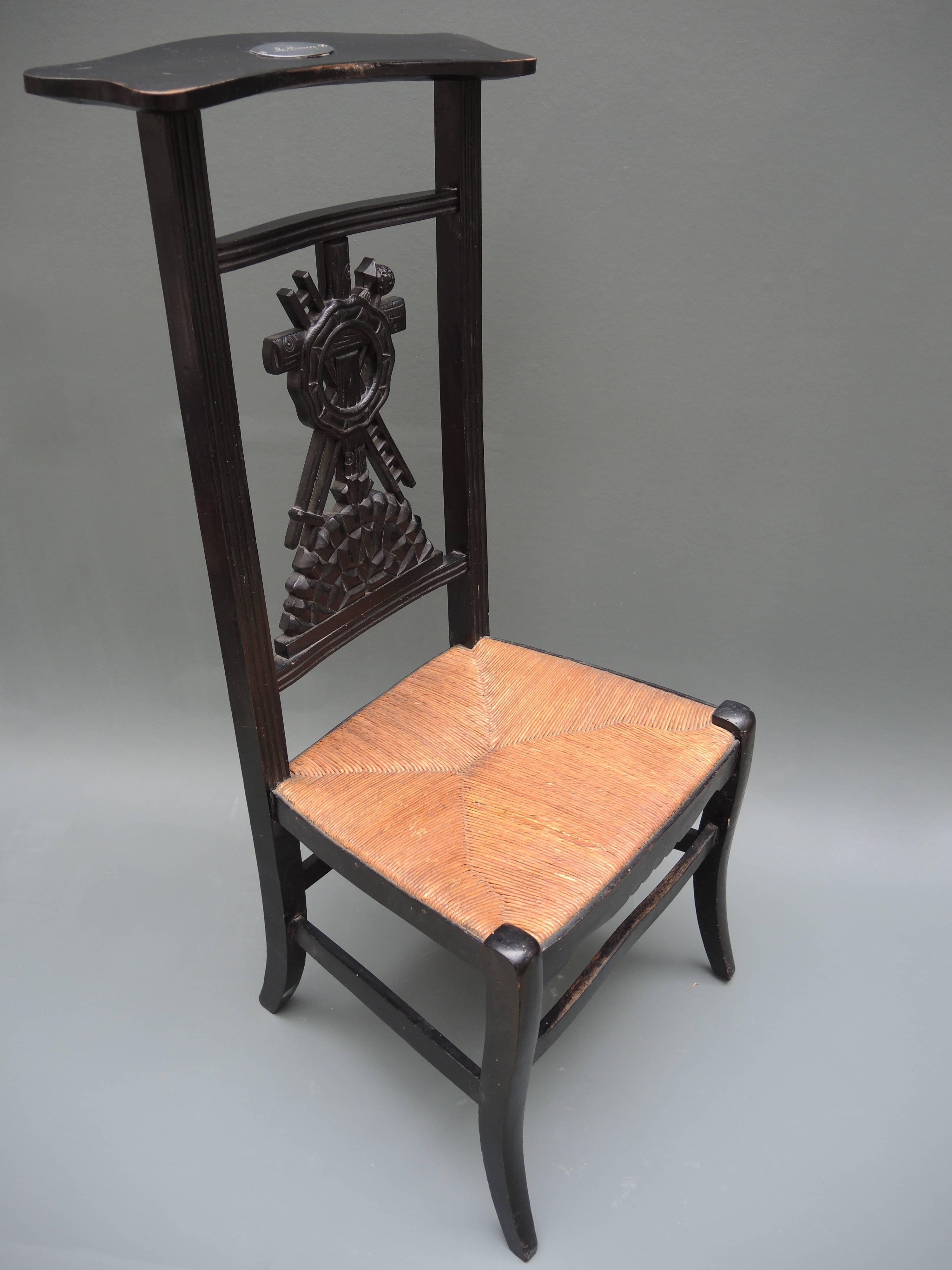 French Provincial prayer chair retaining the original rush seat and paint, circa 1840. The top prayer panel retains the engraved plaque bearing the patron's name. The back splat is hand-carved with symbols of the crucifixion of Christ.

 A wealthy