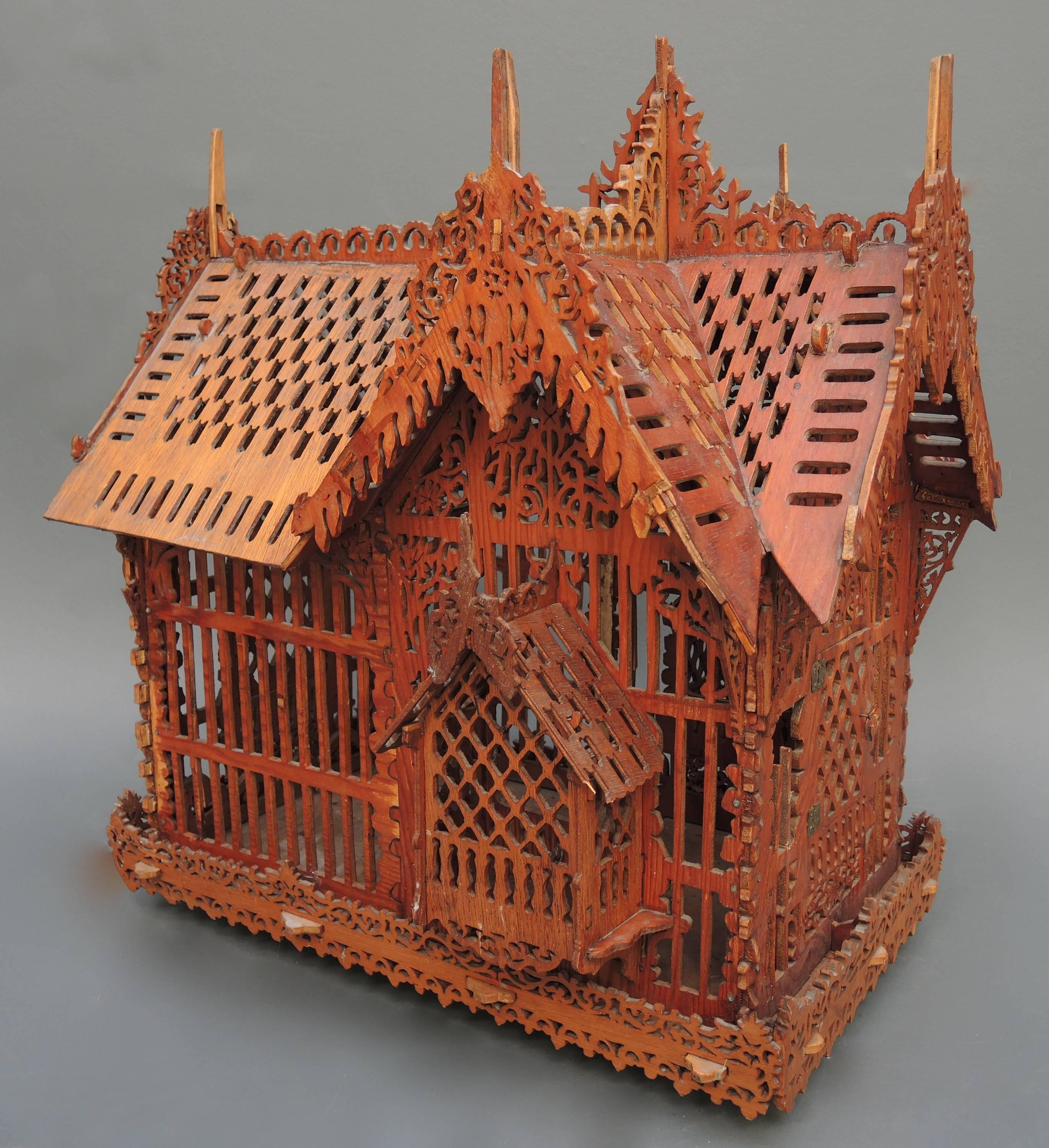 A very unique Folk Art bird cage completely made of fretwork cut wood. 
Fretwork cutting was a very popular Craft in the Netherlands from the mid-19th century up until the beginning of the 1900s. Small shelves and boxes made from cigar boxes and