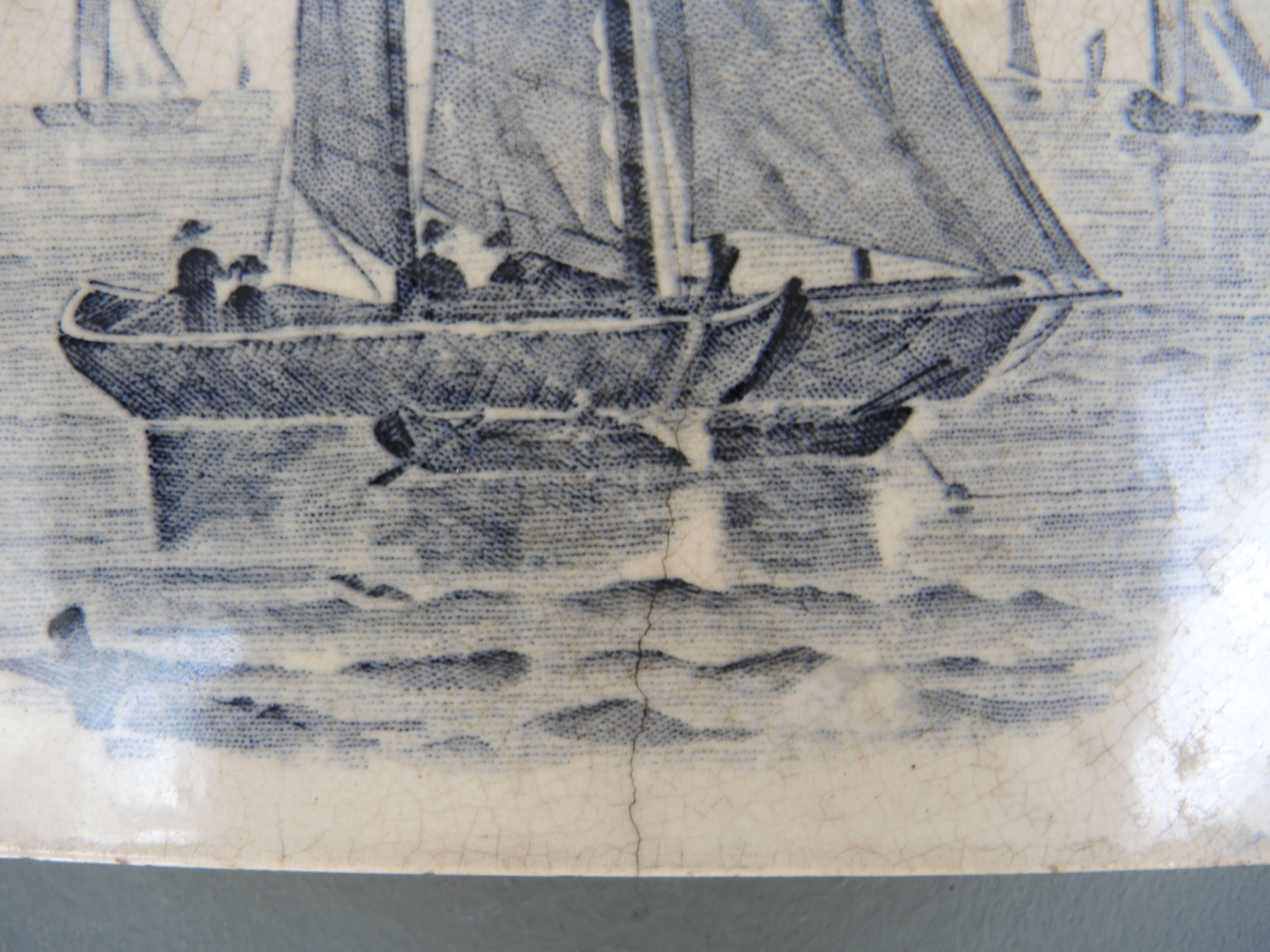 English earthenware glazed tile serving trivet (used to protect the table from hot serving dishes) in creamy white and greyish blue depicting a summer sailing scene.