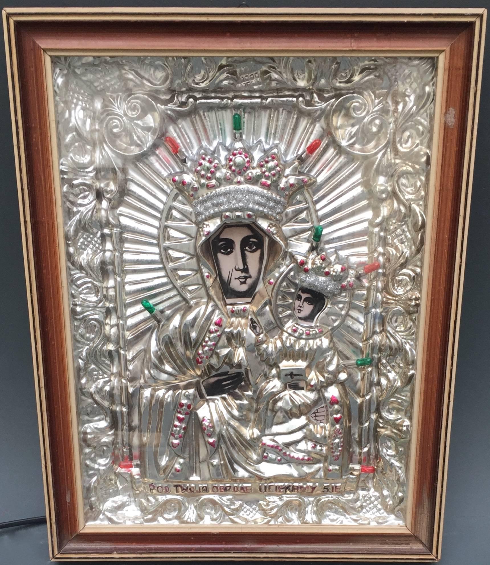 This is a polish midcentury shrine made of molded silvered plastic and retaining the original colored lights that are working. A painted inscription translates to 