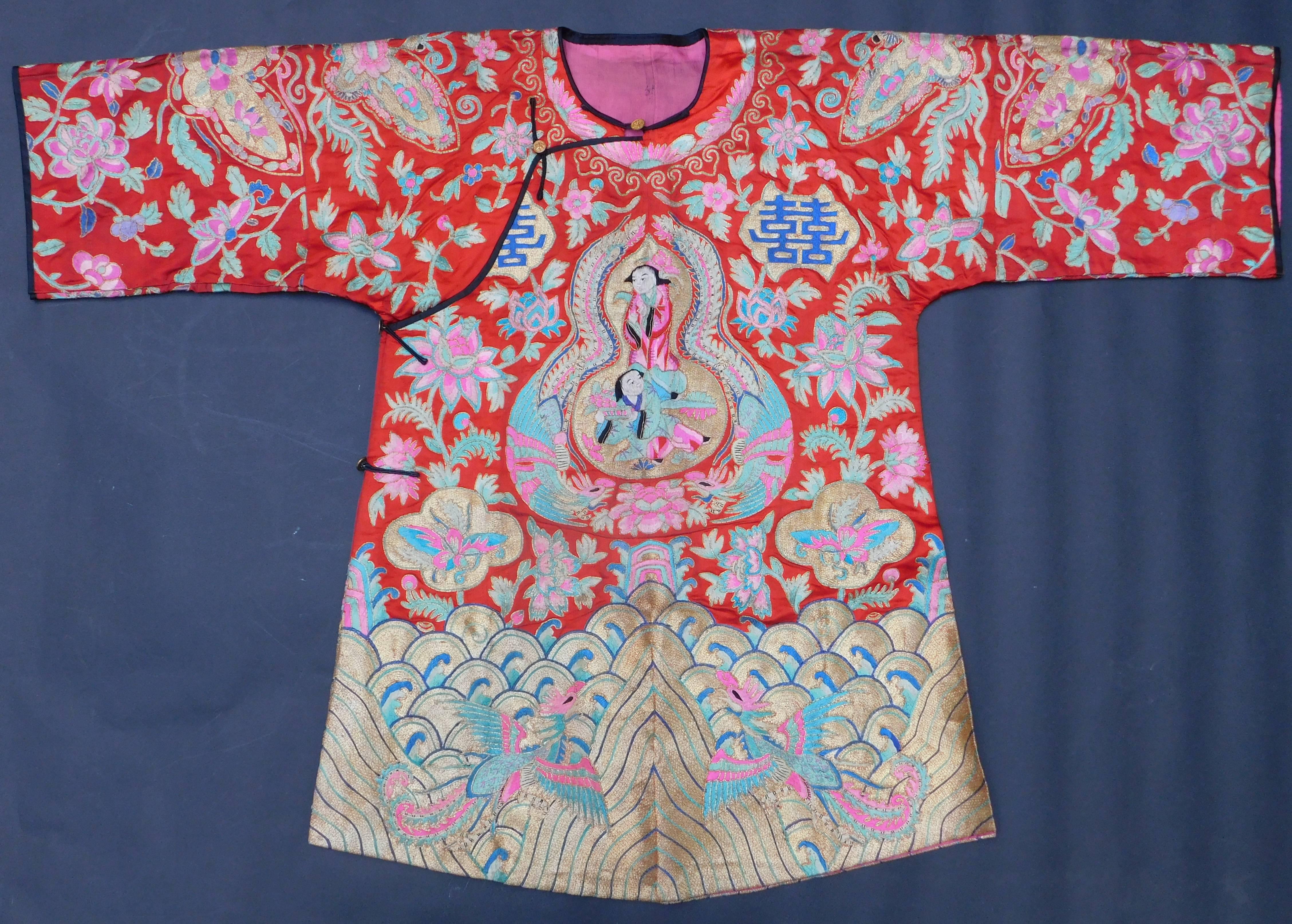 A rare Chinese silk two piece wedding robe and pants set with ornate overall hand embroidery, circa 1920. This is what would be worn for the sedan processional journey transporting a young bride from her home to her husband's family home. The robe