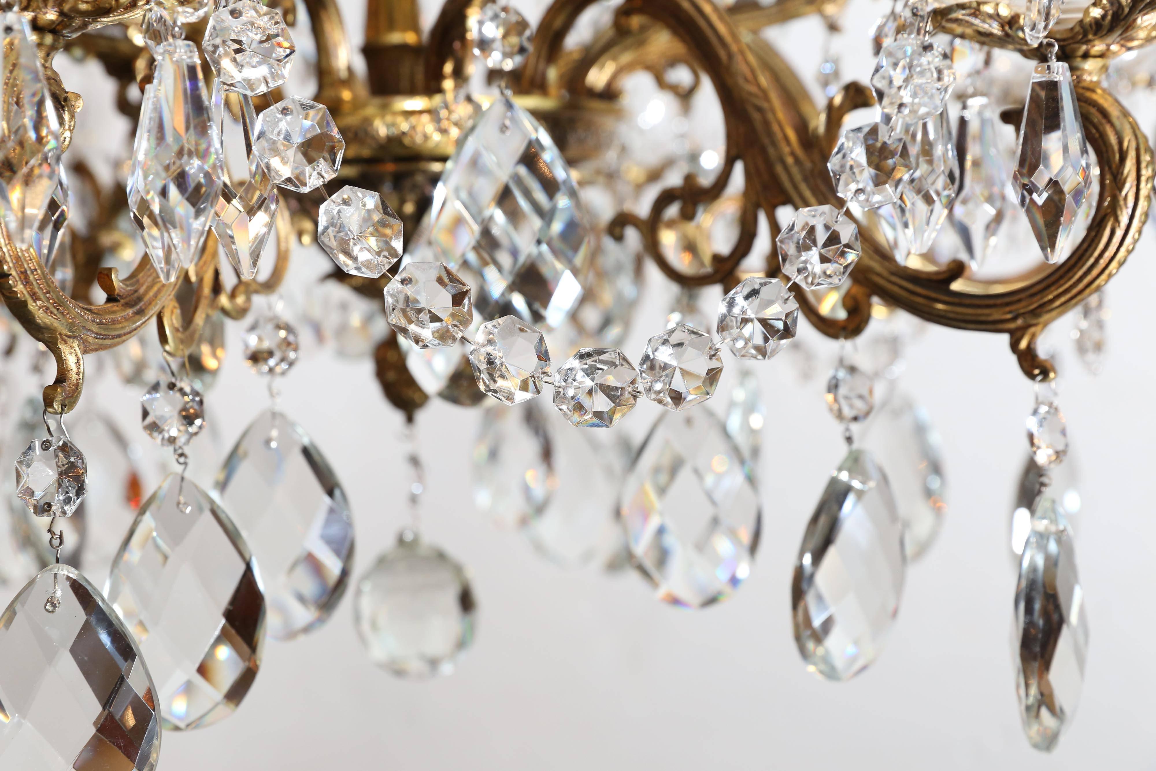 Chandelier has a shiny gold finish and many crystals

Newly cleaned, and glistens like new.