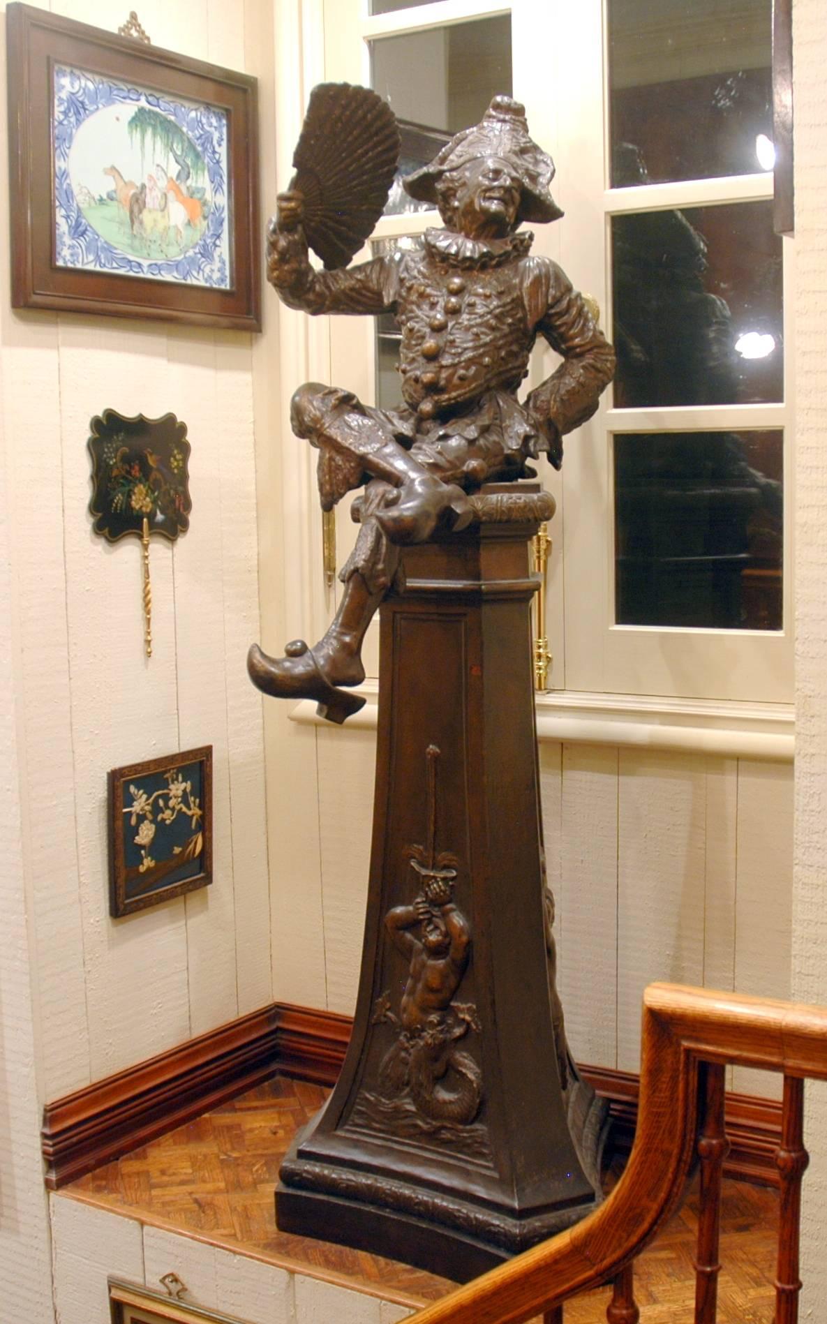 Delightful Court Jester sculpture with a great expression on his face.

The details of this piece are amazing, from the fan he is holding, to the half-off shoe, folds and buttons on his tunic.

Sculpted by LeBlanc.
Foundry was Tusey under A.