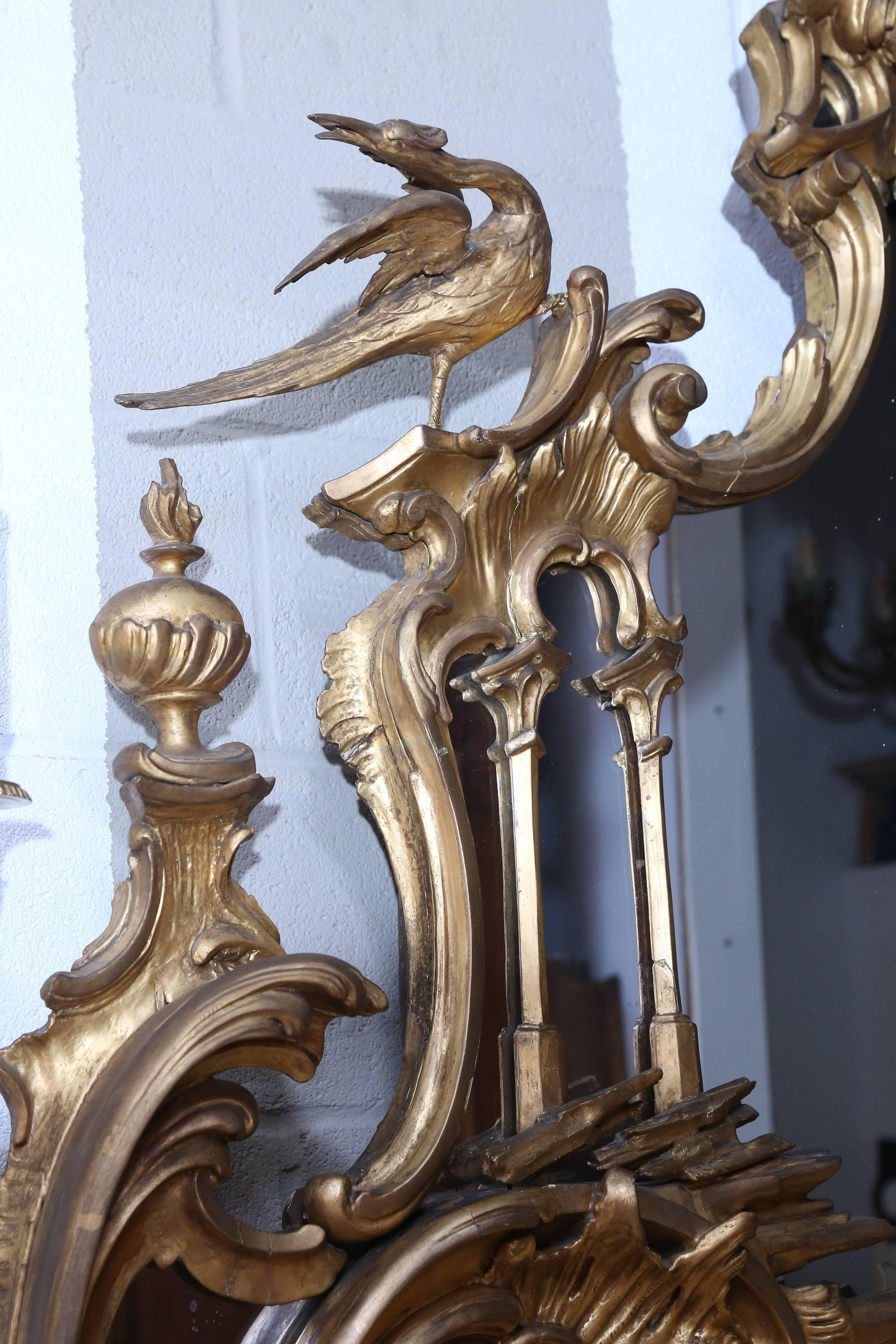 Very unusual gilt late 18th-early 19th century carved and gilt asymmetrical mirror. 
There are several carved animals featured all-over this mirror, which includes an owl, birds, a squirrel, and more...

Extremely dramatic.


.