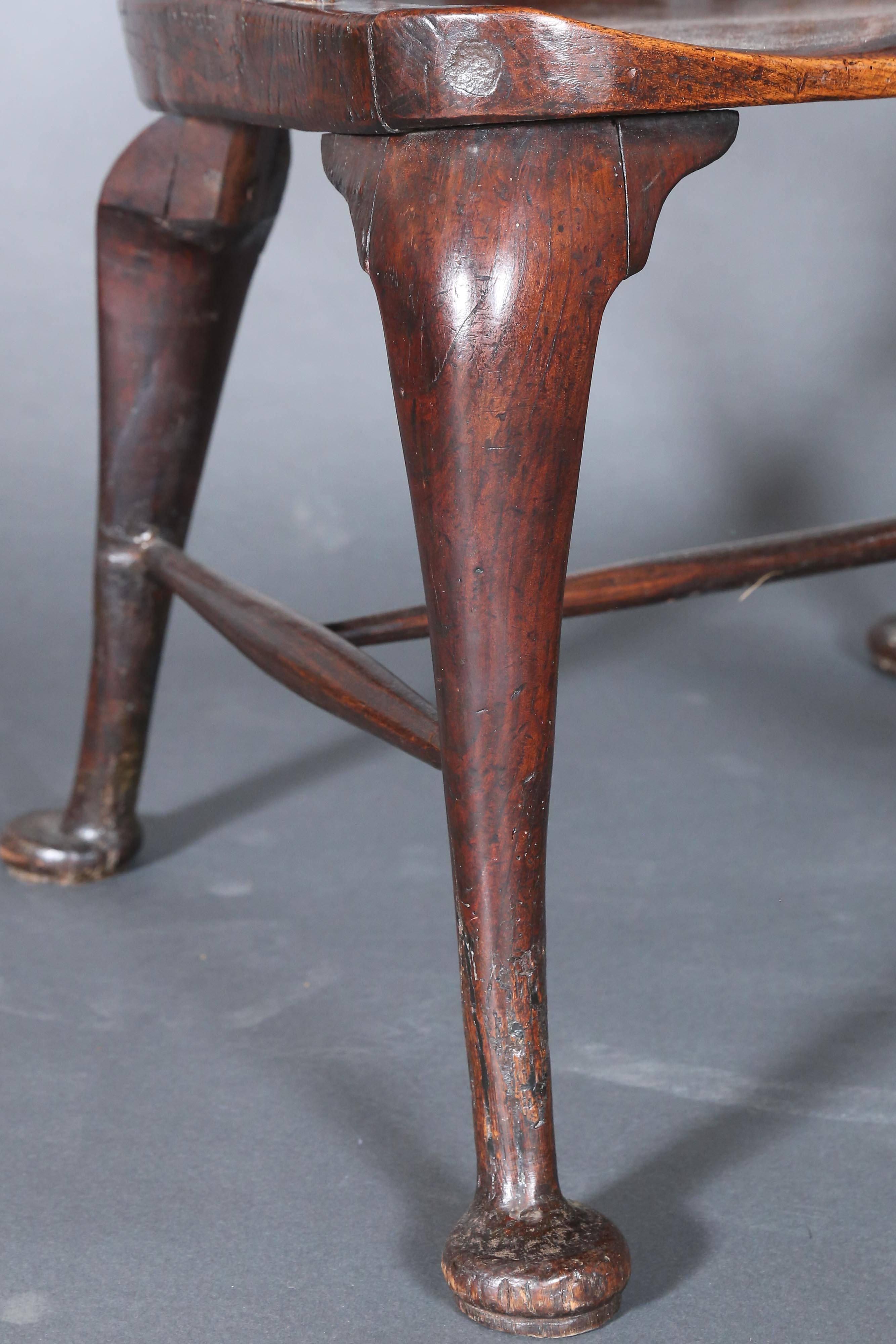 18th English oak windsor chair has a very distinct look, as it is tall and narrow Shaker look.
Chair has a saddle seat and Queen Anne cabriole legs with pad feet.
Rear legs are also cabriole, which is quite unusual.
Back has 16 spindles with