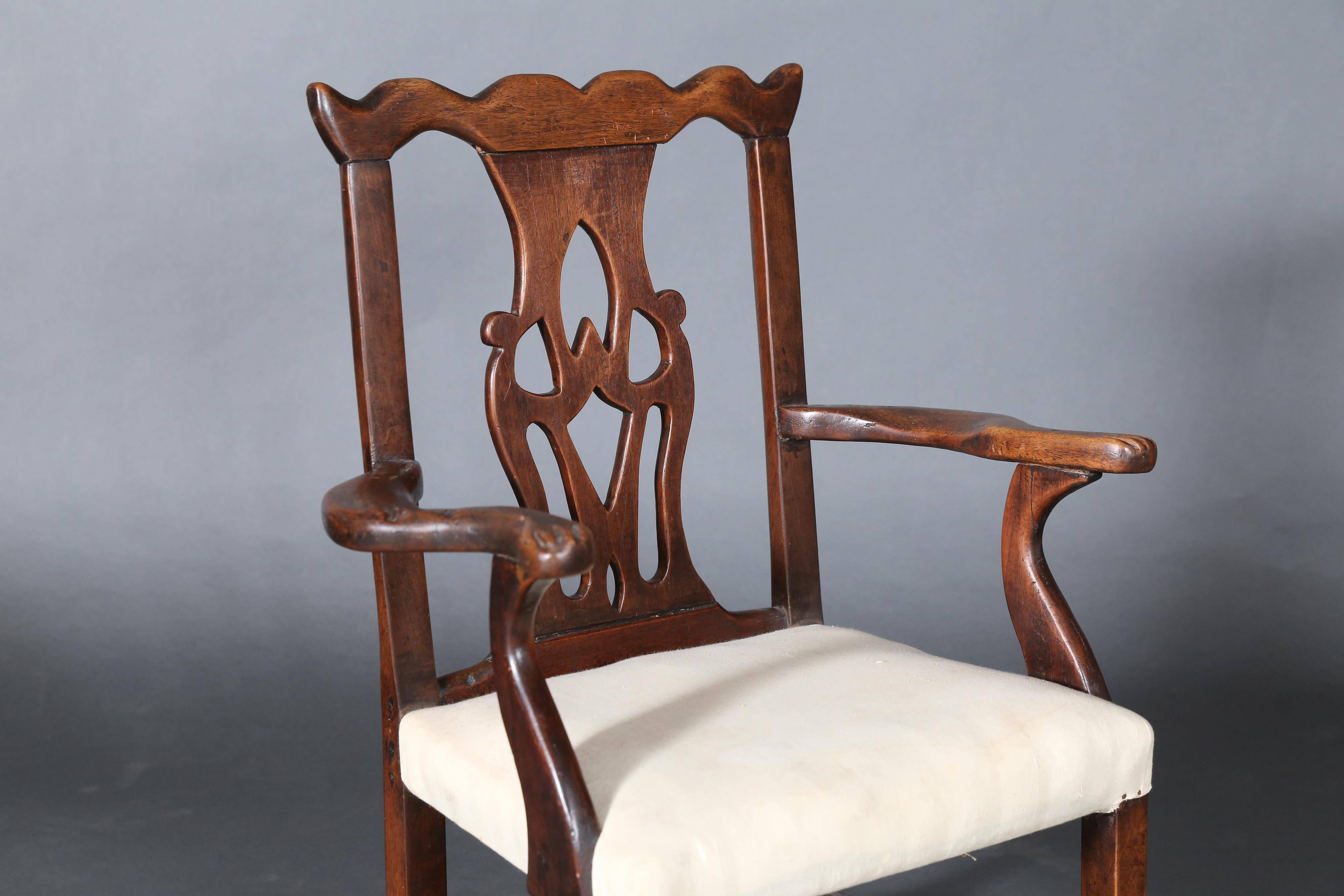 Antique mahogany Chippendale chair has a pierced back splat topped with a carved crown shape.
Arms are nicely shaped with a paw carving on ends.
 