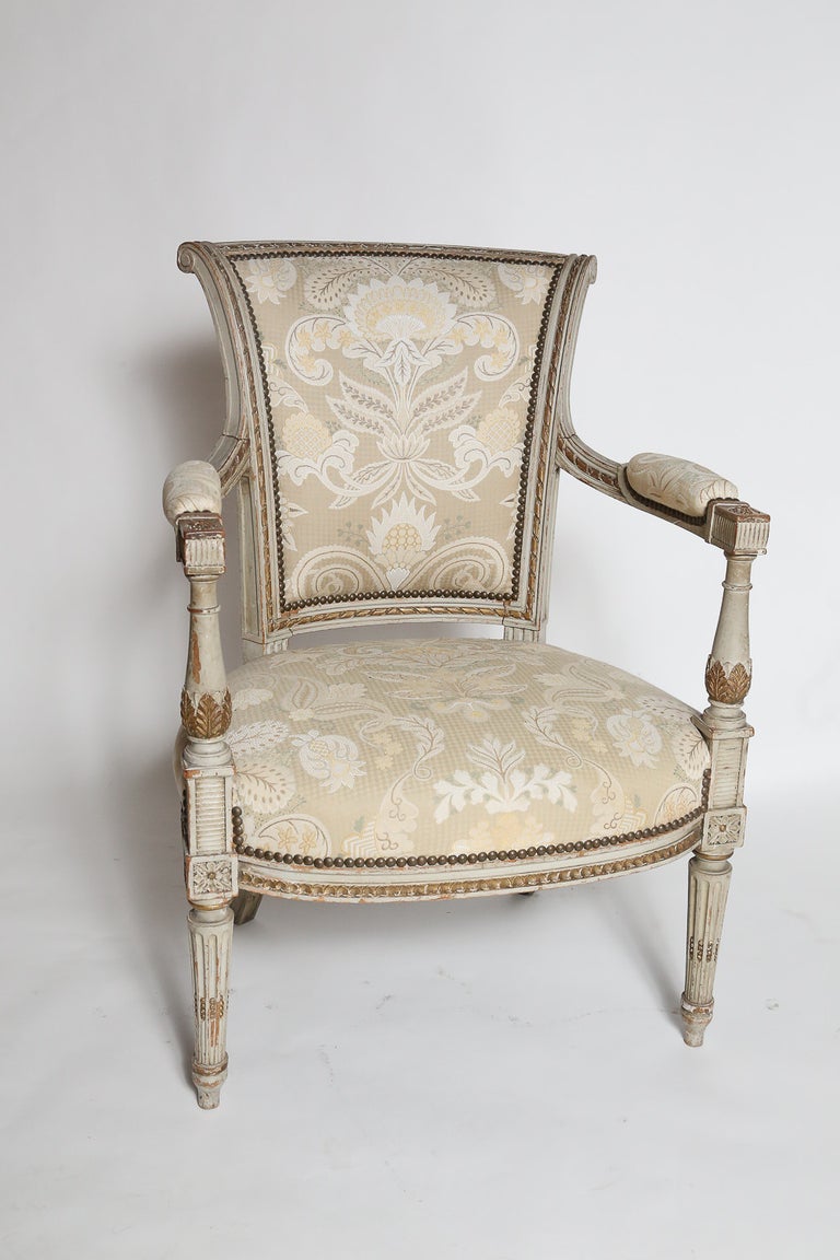 Pair of carved and painted Louis XVI-style fauteuil. 

Size and seat height is applicable for both dining or lounge. 

Upholstered in Scalamandre Jacquard fabric.
