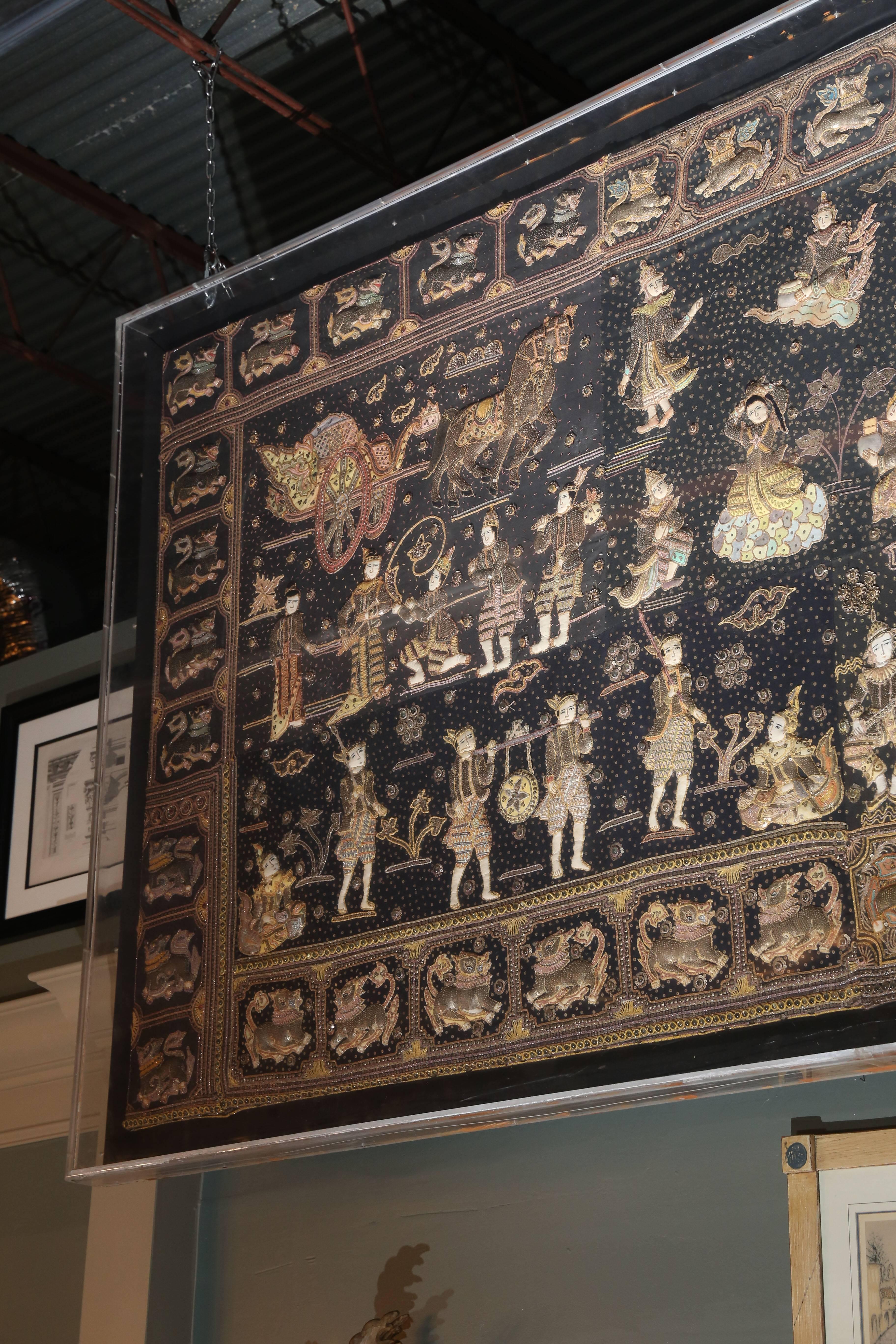 "Kalaga" is the name for embroidered tapestries from Burma.
They are traditionally made of linen, silk, velvet, and cotton, and adorned with stones, beads  and sequins.

They commonly depict the Journeys of Buddha towards Enlightenment