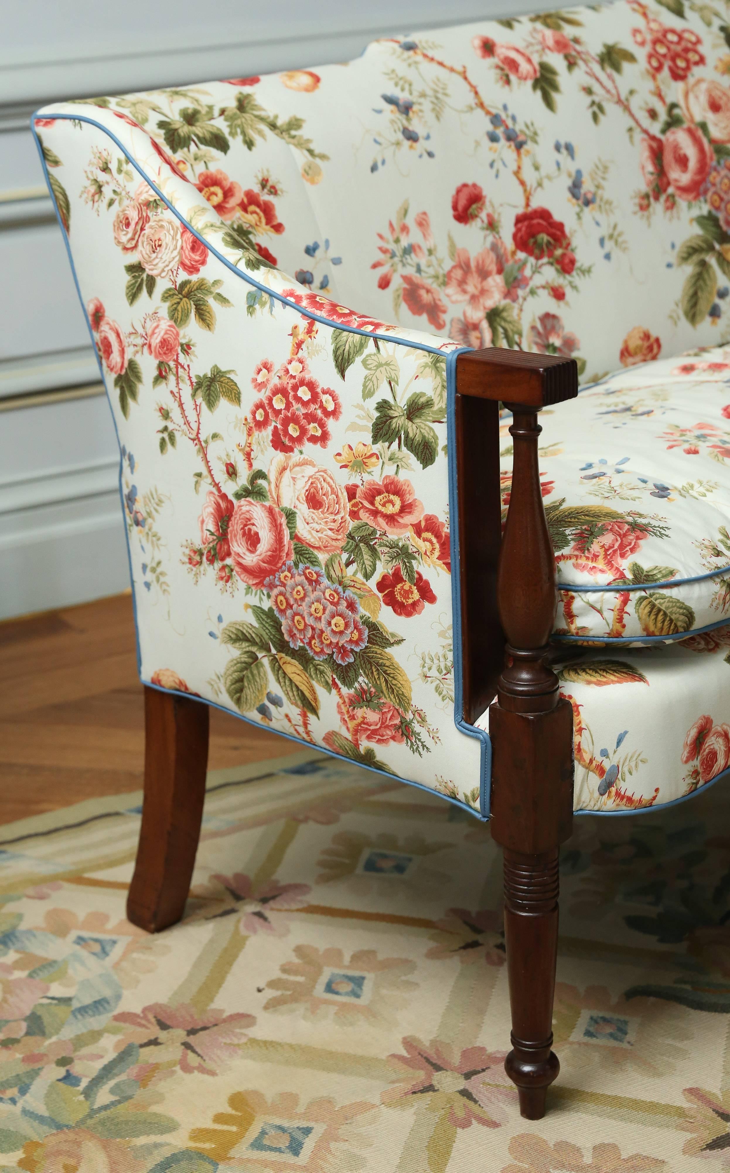 Mahogany settee with turned front legs and arm fronts.