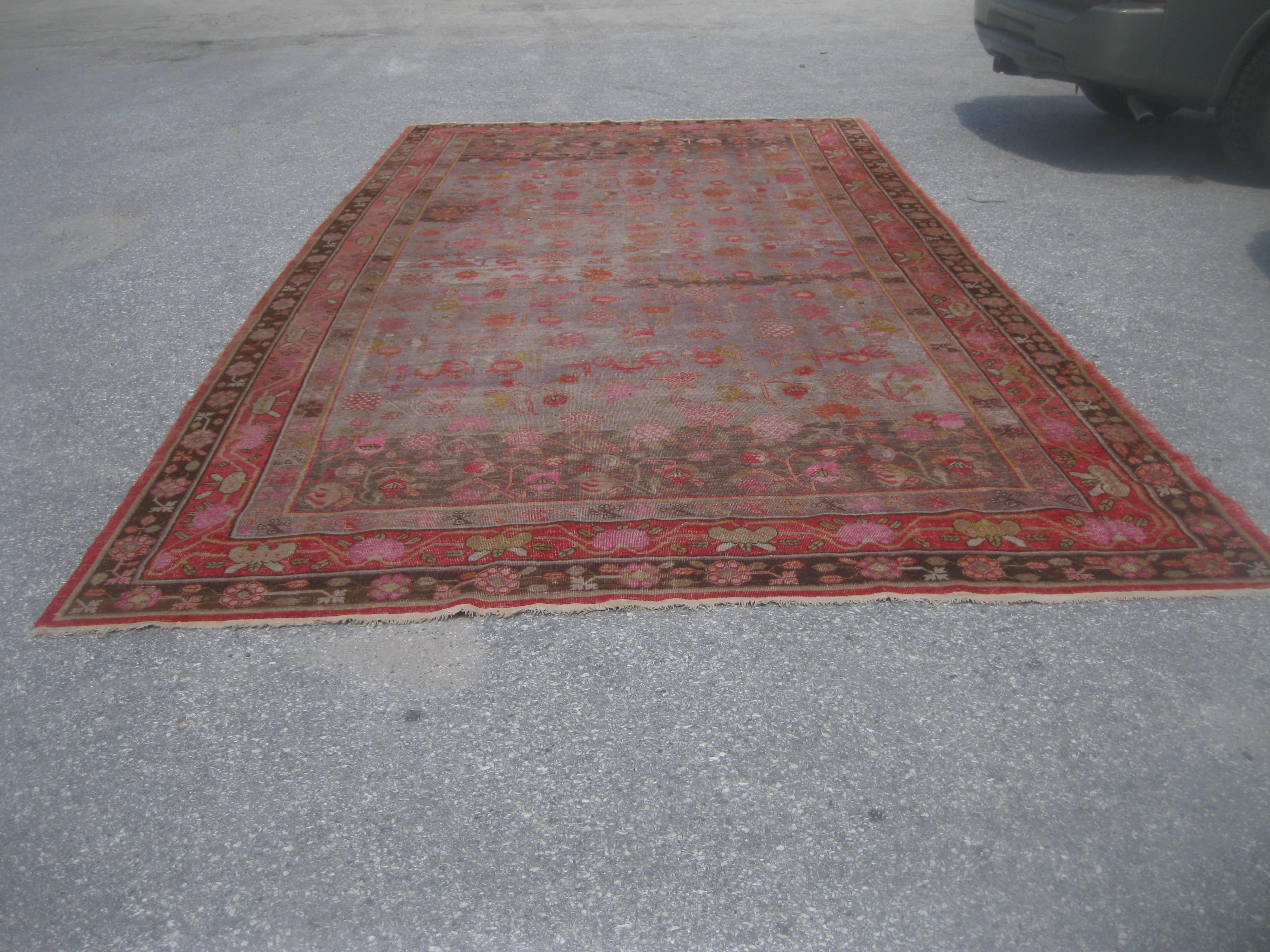 Very handsome large Khotan rug with geometrical designs.

Background of rug field is much lighter tending toward the grays, with more muted pattern.

                  