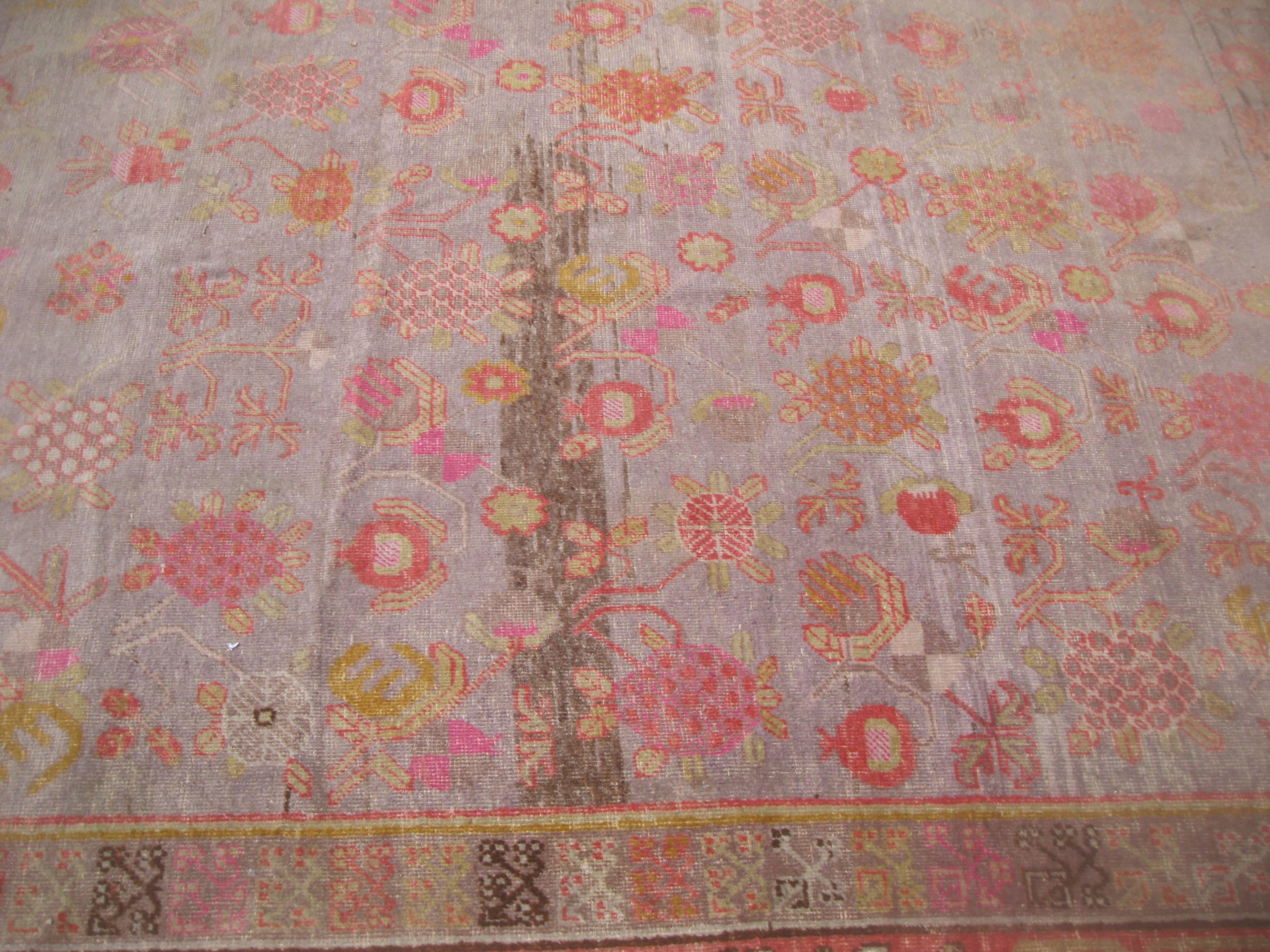 Hand-Woven Antique Khotan Rug with Eight Band Border in Browns and Oranges For Sale