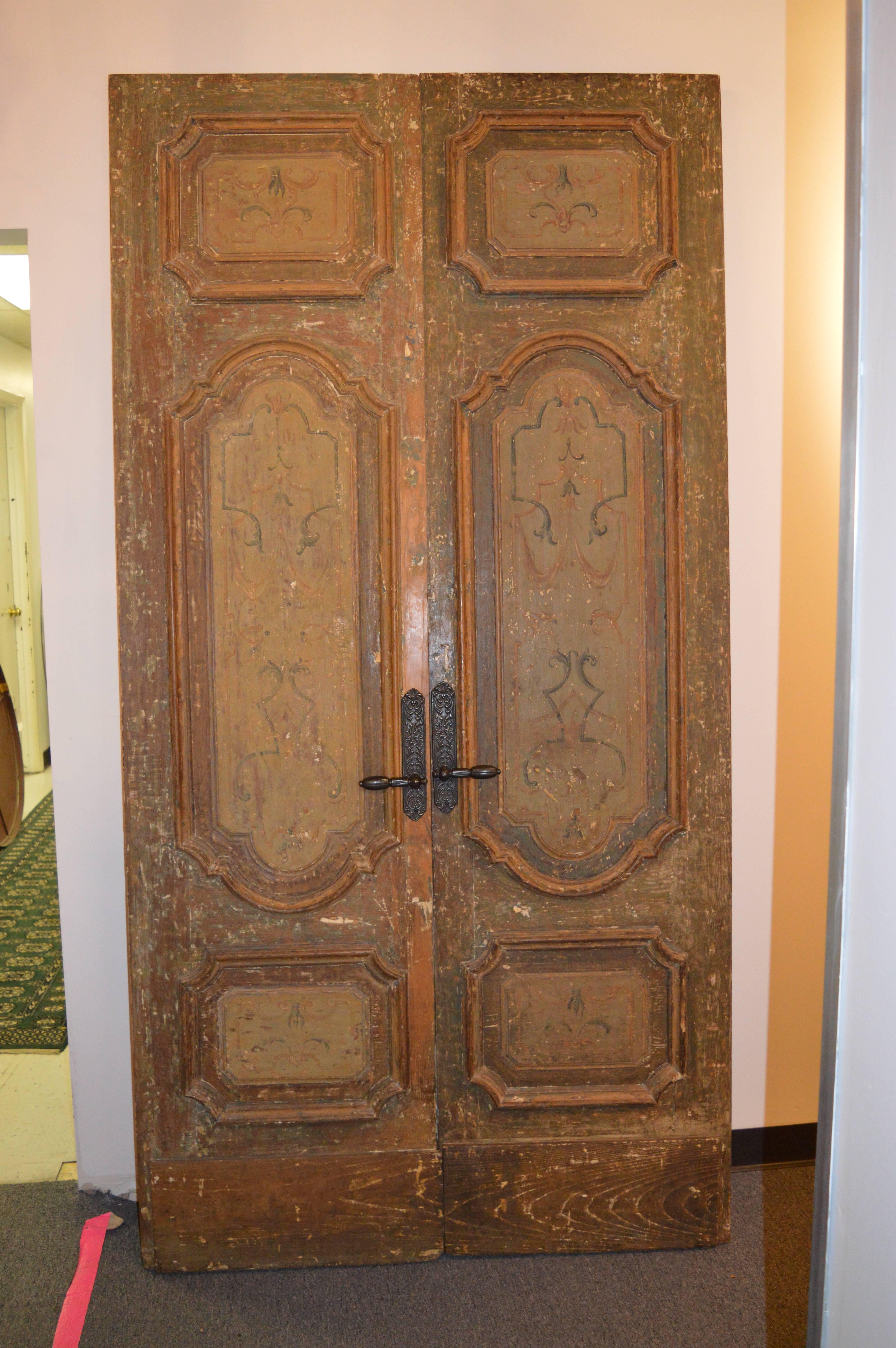Wonderfully painted and aged pair of doors include the original hardware.

Probably originally brightly painted, they have muted with age.
