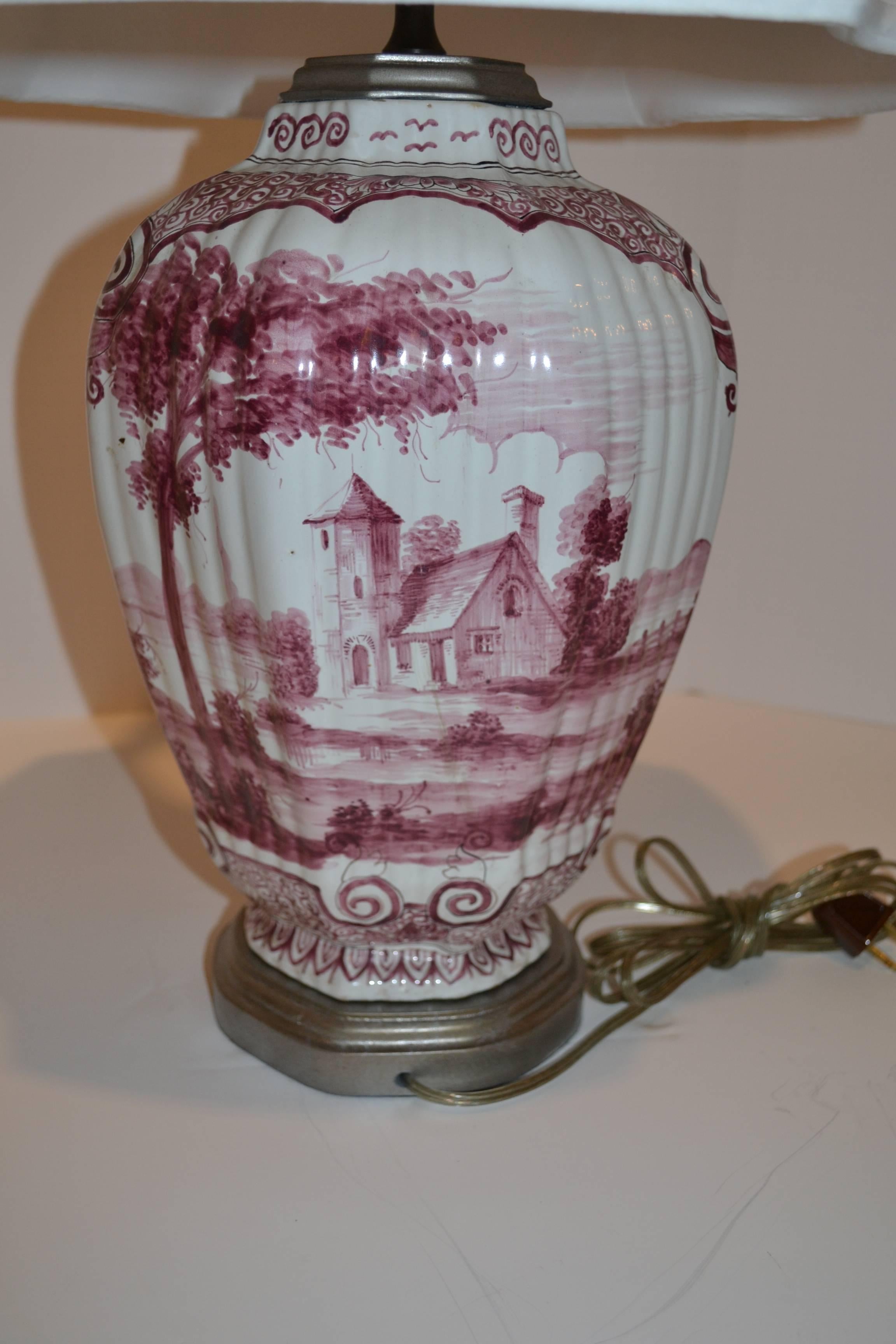 Historically painted jars feature scenes of country living in the Netherlands.
Front and back paintings divided by floral designs that wraparound top and bottom of vases.

Silver gilt painted base and pewter finials finish this lovely