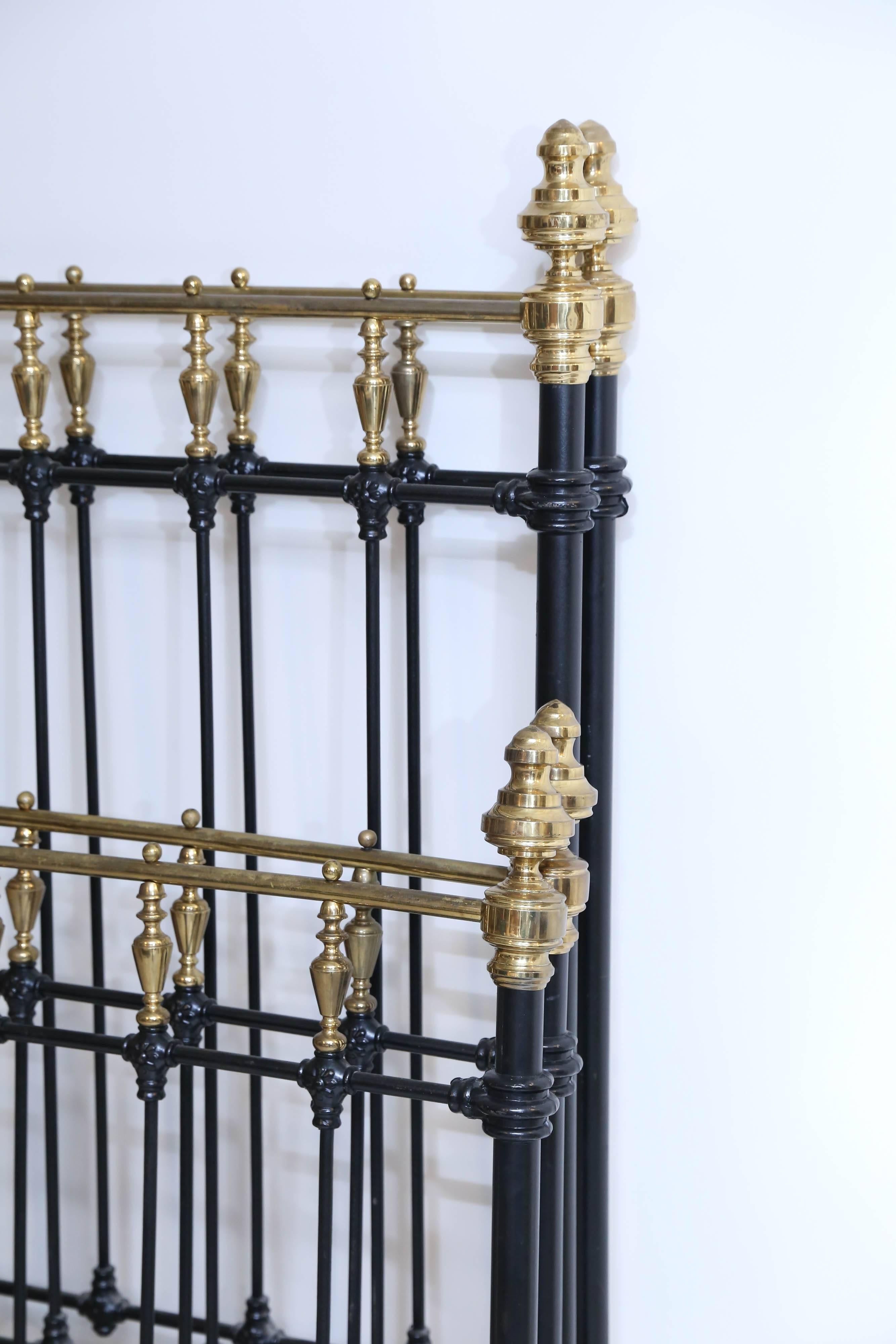 Very handsome pair of painted black cast iron beds with polished brass tall finials.
Beds from a French Nunnery are a bit smaller than standard twin.