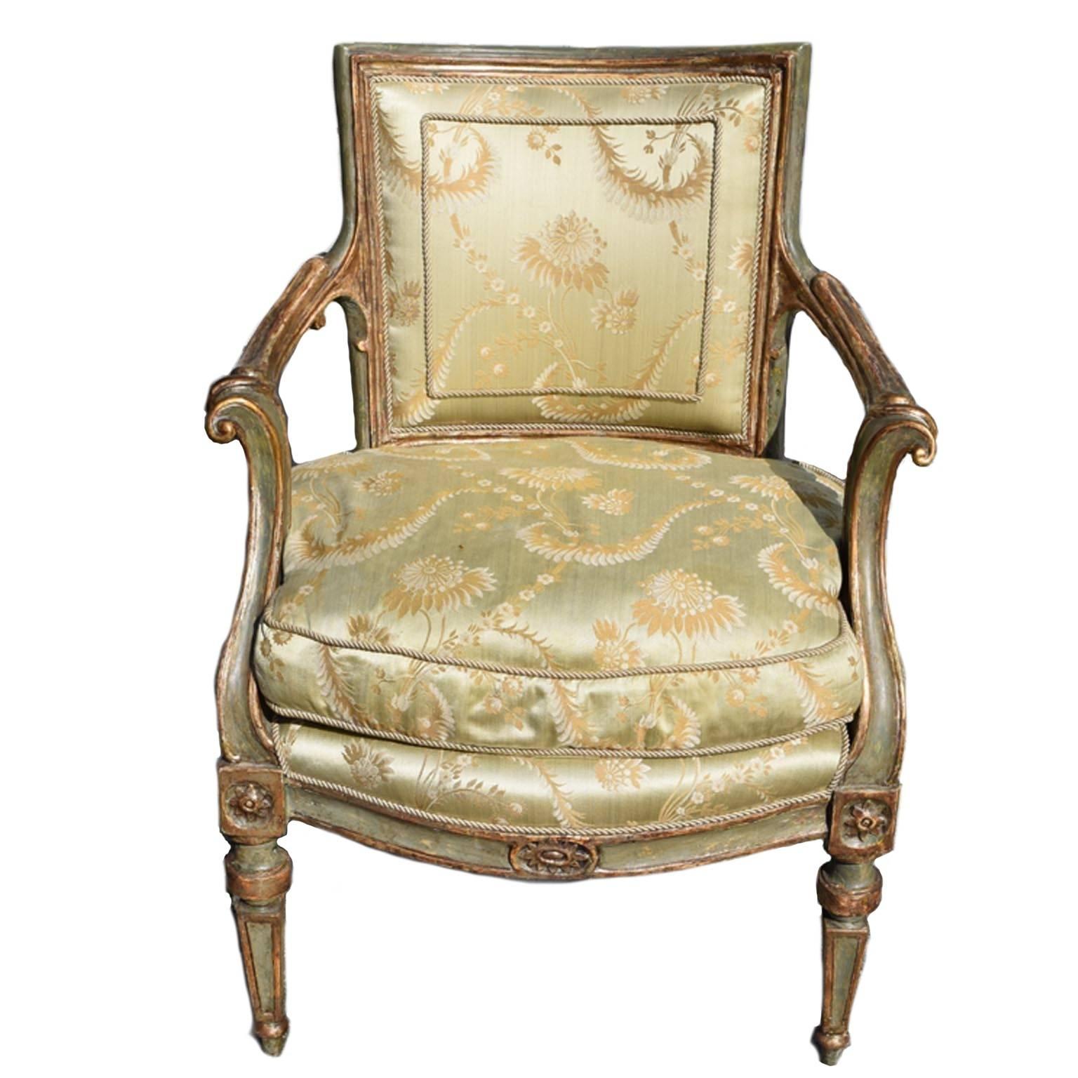 Italian green-painted and parcel-gilt neoclassical armchair has a bowed
rectangular backrest within a moulded border, circa 1780.

Chair has scrolled armrests raised on tapering fluted supports, above a bowed loose cushion seat, raised on square