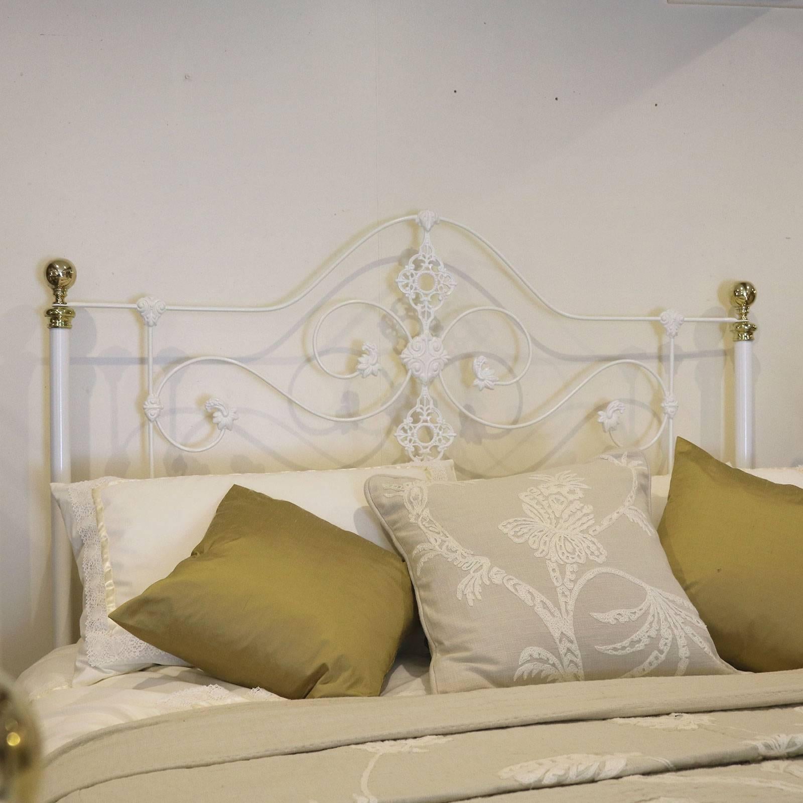 A fine mid-Victorian cast iron bed finished in antique white with ornate castings and brass finials.

This bed accepts a British king-size or American queen-size (60 in or 5 ft wide) base and mattress set.

The price is for the bed frame alone.