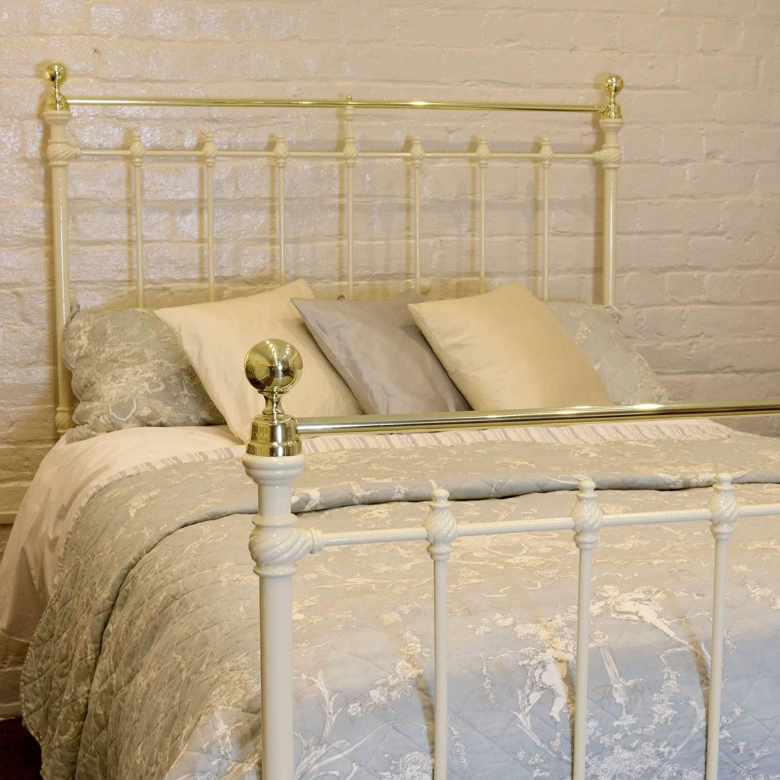 A Victorian brass and iron bed finished in cream with decorative barley twist castings, straight brass top rail, cap collars and brass knobs.

This fine example of an antique brass and iron bed accepts a double base and mattress set, 54 inches
