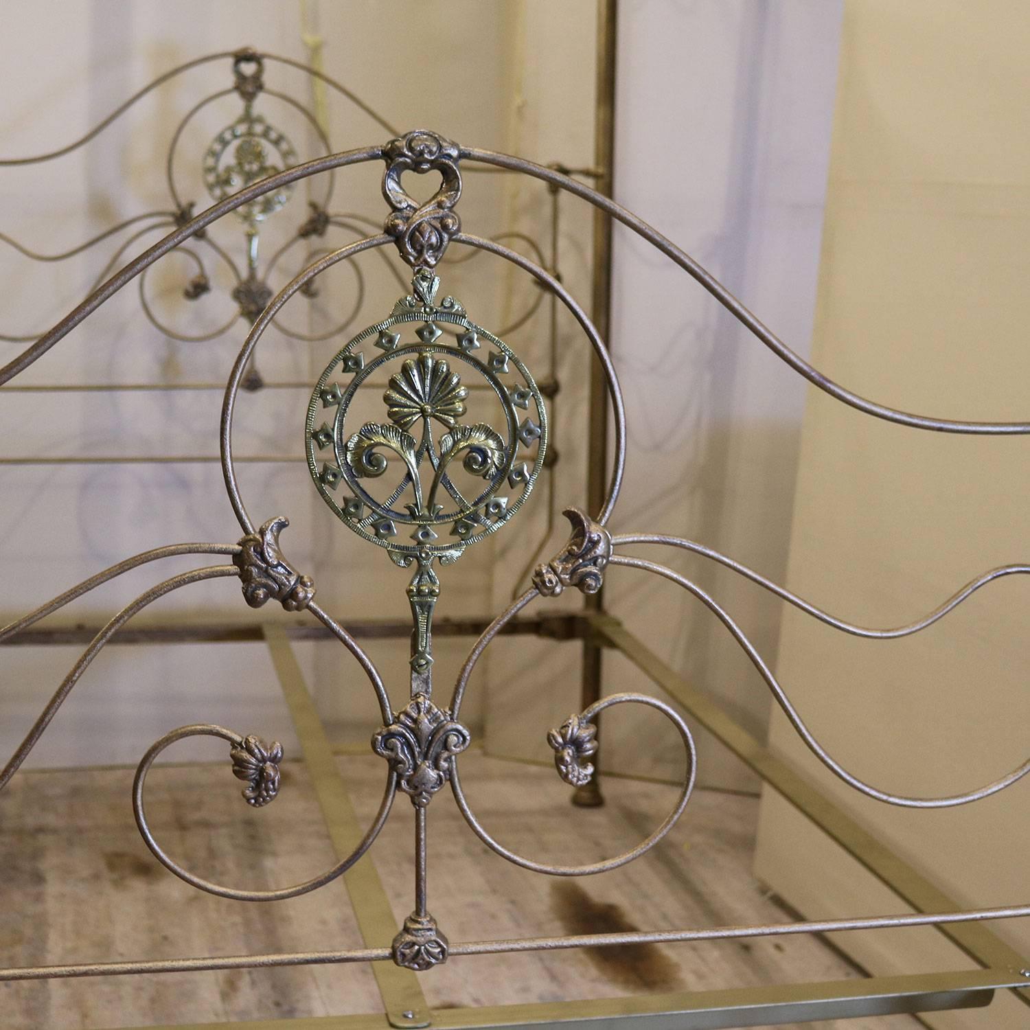 A cast iron half tester bed from the mid-Victorian era finished in gold with decorative brass fittings and brass central casting. The tall half round canopy can be used to suspend drapes, or left bare, or totally removed if required. M4P22.

This