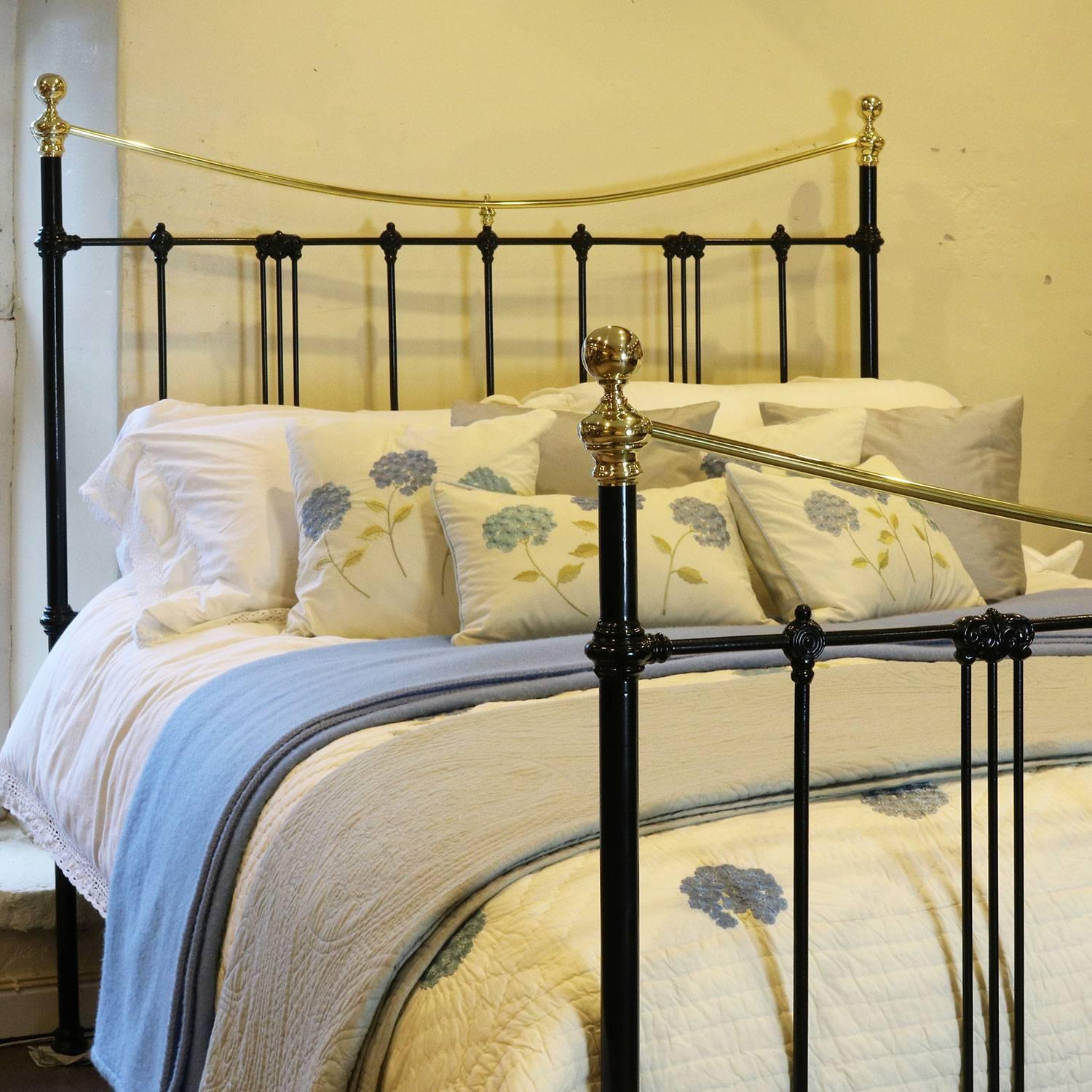 A brass and iron bed finished in black with a curved brass top rail and Art Nouveau castings.

This bed accepts an American Queen or British king-size (60 inches, 5ft or 150cm) base and mattress set.

The price is for the bed frame alone. The