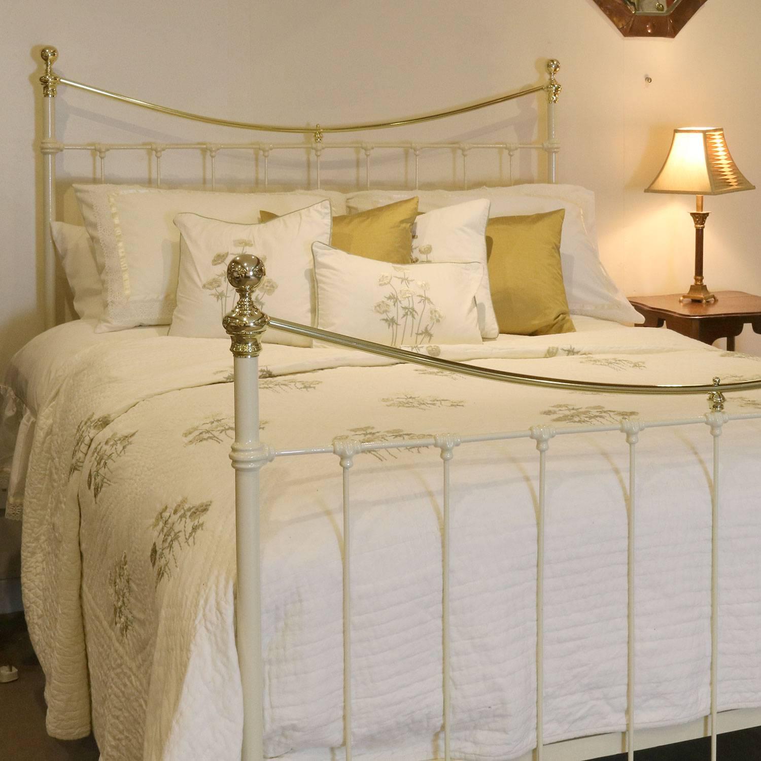 A brass and iron bed finished in cream with a curved brass top rail and simple castings.

This bed accepts an American Queen or British king-size (60 inches, 5ft or 150cm) base and mattress set.

The price is for the bed frame alone. The base,