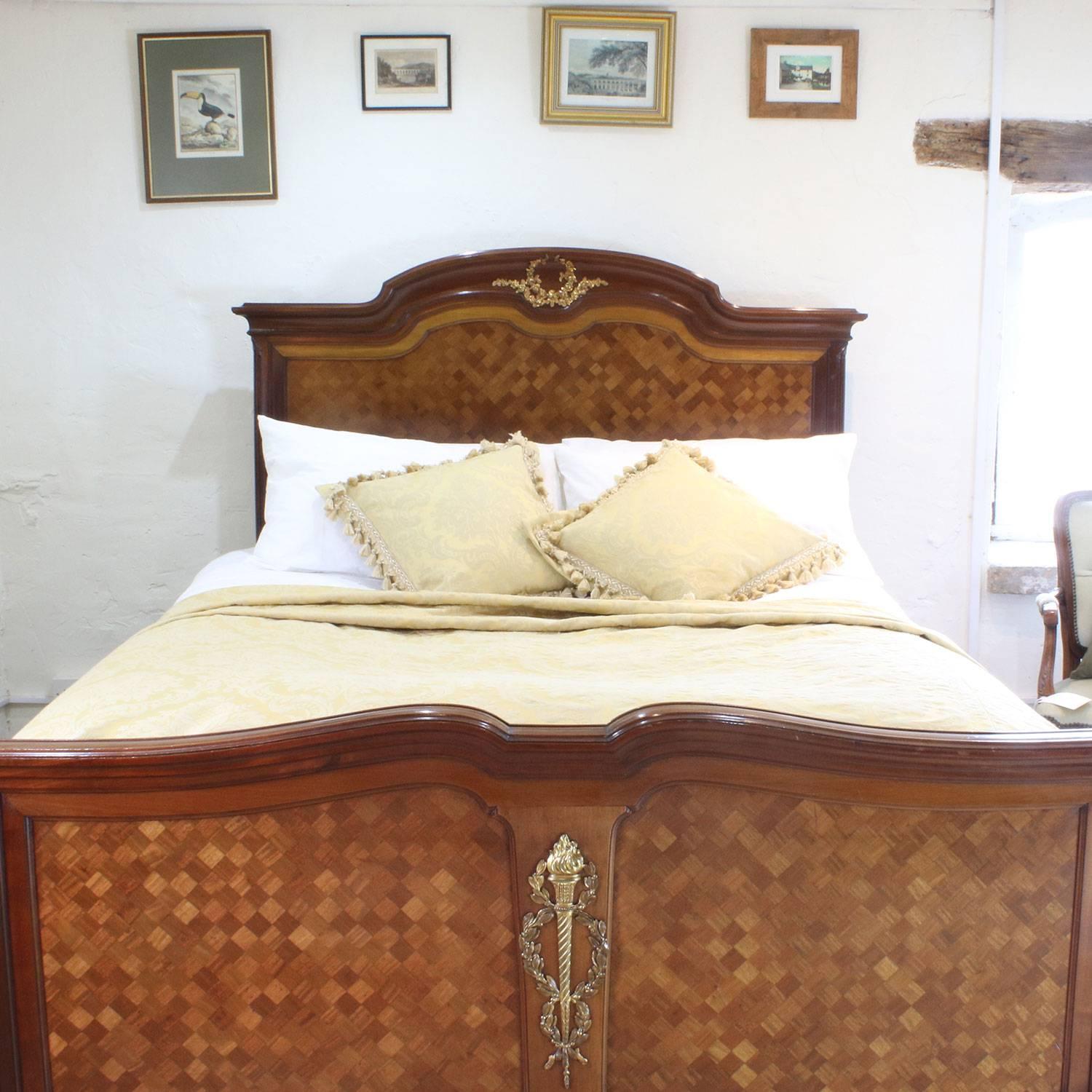 A fine parquetry Empire style bed in mahogany with fruitwood inlay and ormolu decoration.

This bed accepts a British king-size or American queen-size (60 inches, 5 feet or 150 cm) base and mattress set.

The price is for the bed frame alone.