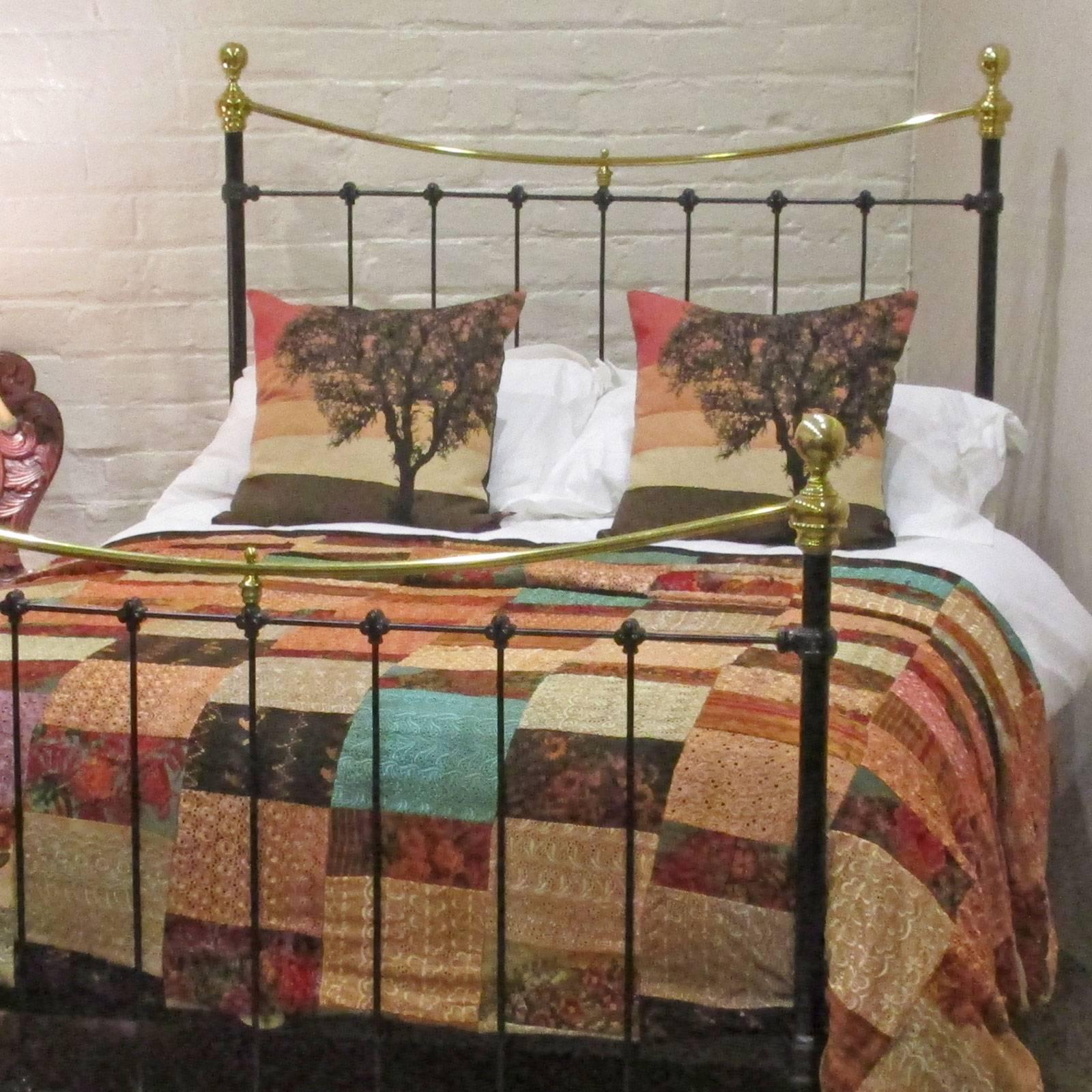 A pretty double antique bed with dainty cast iron mouldings. Finished in stove enamelled black with curved top brass rails and finials.

This bed accepts a standard double (4ft 6 in x 6ft 3in) base and mattress set.

The price is for the