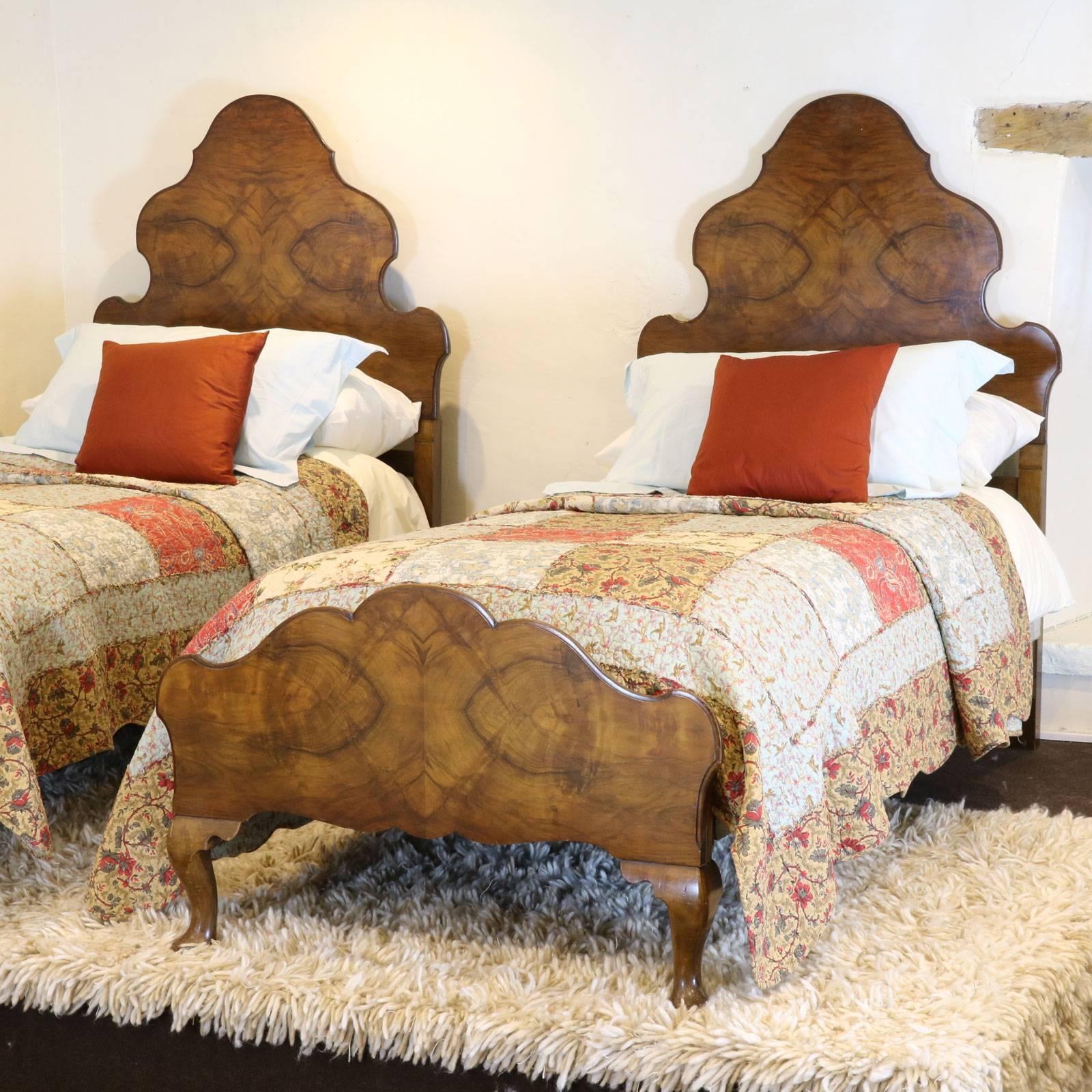 This matching pair of Queen Anne style beds have an elegant shape to both head and foot boards. 

The price is for the beds alone, the bases, mattresses and bedding are extra and can be provided by Seventh Heaven.
The pair accept standard single