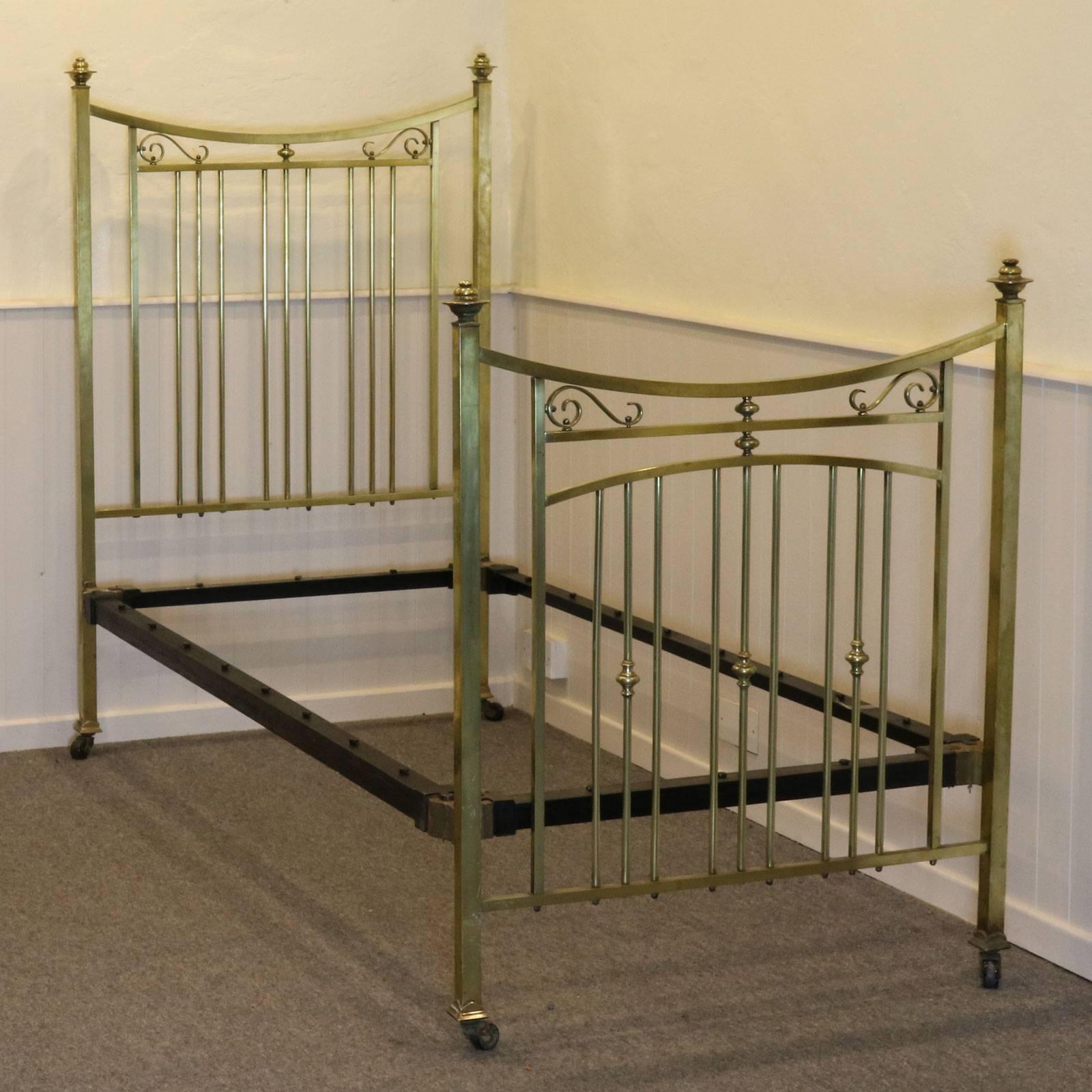 This pair of beds from renowned manufacturer Heals are fine examples of Edwardian style with square section brass bars, pagoda caps and elegant decoration in the form of swirls and finials. The condition is original with a patina acquired over 100