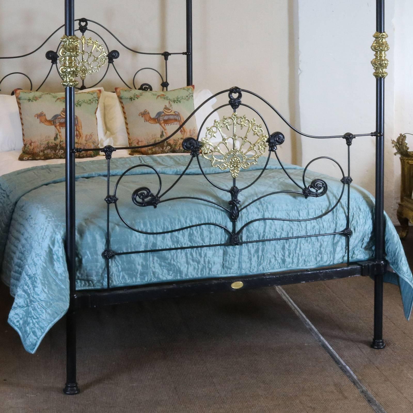 A superb cast iron four poster bed adapted from an original mid-Victorian frame dating back to 1880 with cast central brass plaque, collars and finials. This four poster comes with the straight canopy as shown in the photographs or an arched canopy