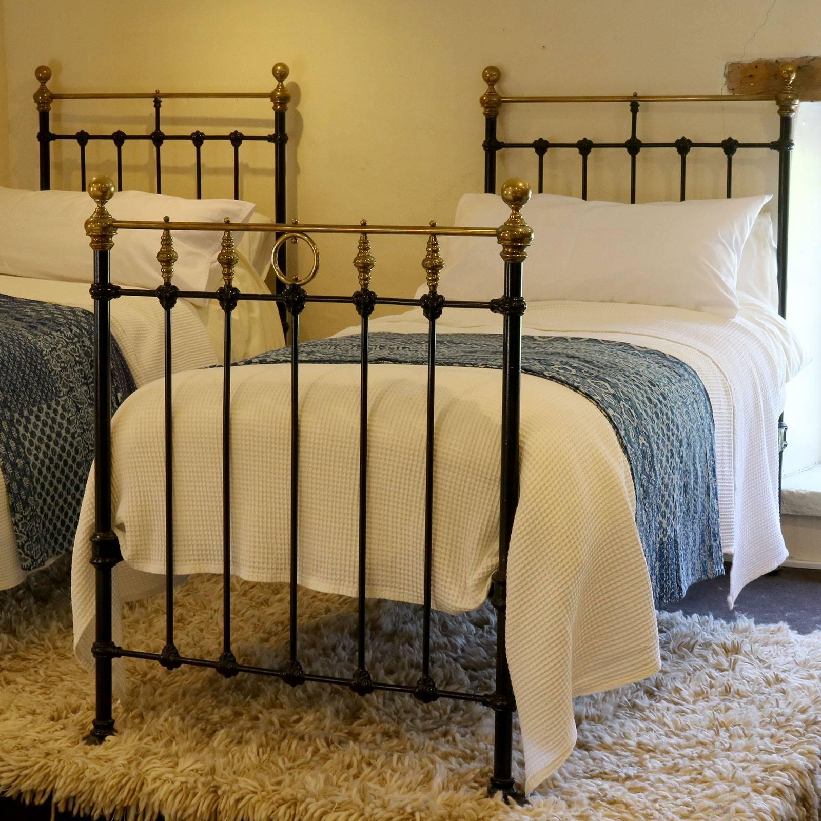 A matching pair of twin brass and iron beds finished in black with brass top rails and ring and twist decoration.

These beds accept 3 ft wide (36 inch or 90 cm) bases and mattresses.

The price is for the beds alone, the bases, mattresses,