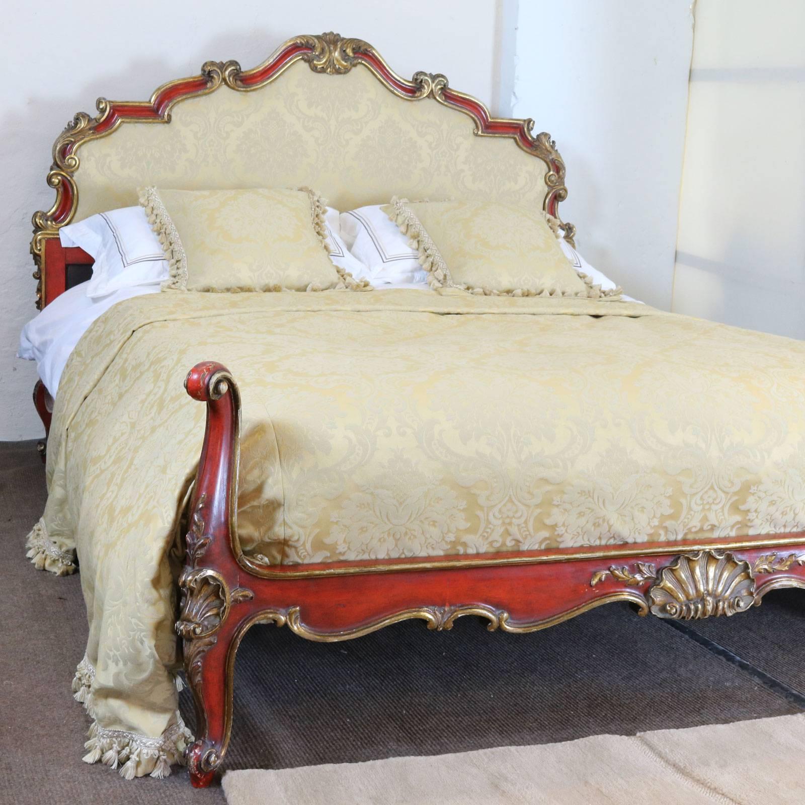 Wide Italian bed with red painted frame and gilded carvings. The cream damask upholstered backboard has an ornate frame and the low foot board has torchon feet.

This bed accepts an extra-wide 63 inch (5ft 3in or 160cm) base and mattress, which