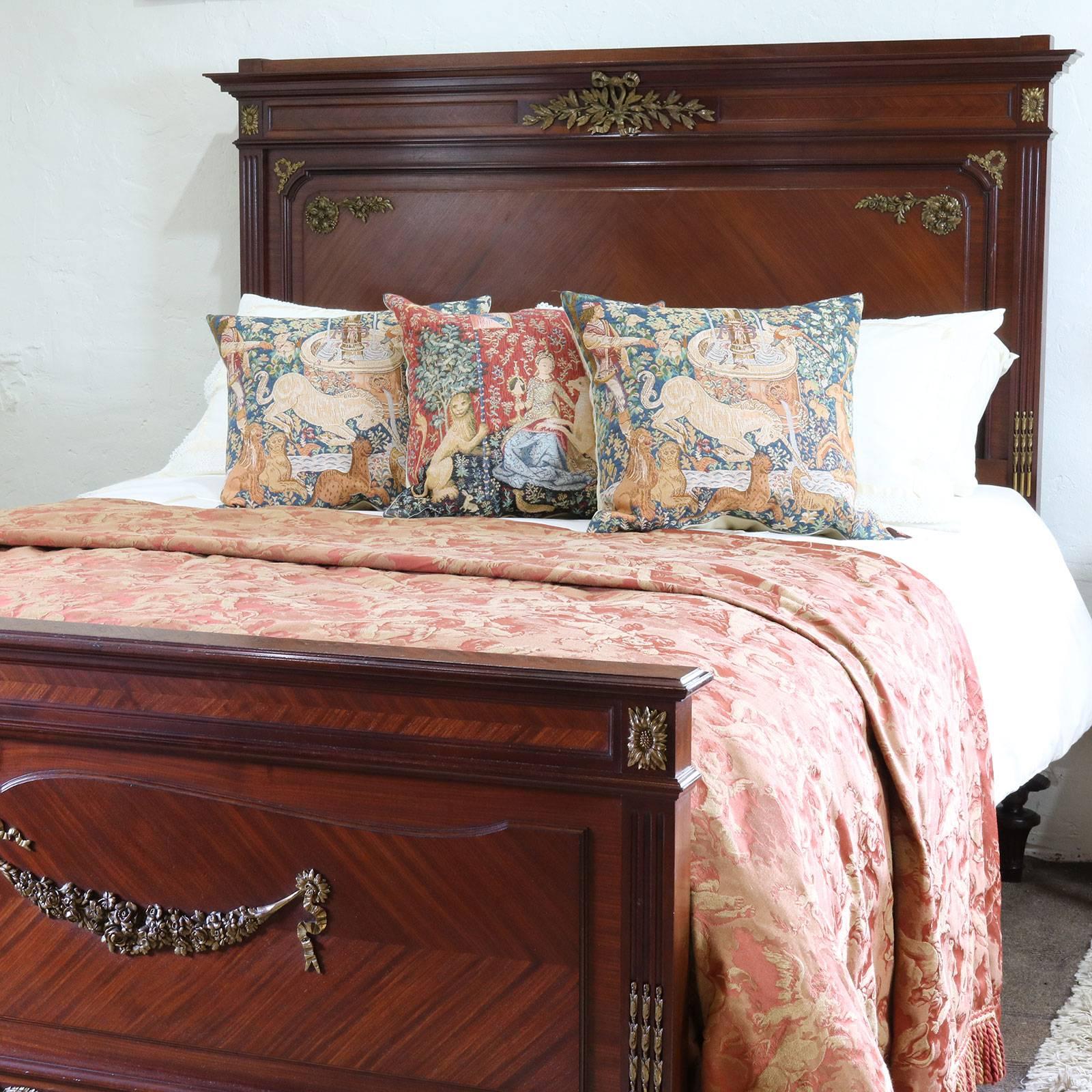 A wide French bedstead in the Empire Revival style with quartered veneer panels and ormolu decoration.

This bed accepts a British kingsize or American Queen Size (60 inches wide) base and mattress set, although it will accept a wider 63 inch or