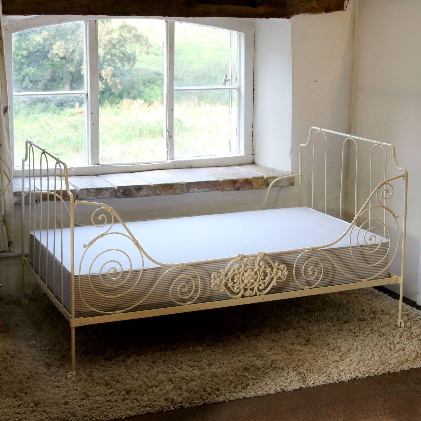 A French metal daybed with swirling panel decoration and central cast feature on the front runner.

This bed accepts a specially made base and mattress roughly 42 inches wide by 72 inches long.

The price is for the bed frame alone. The base,