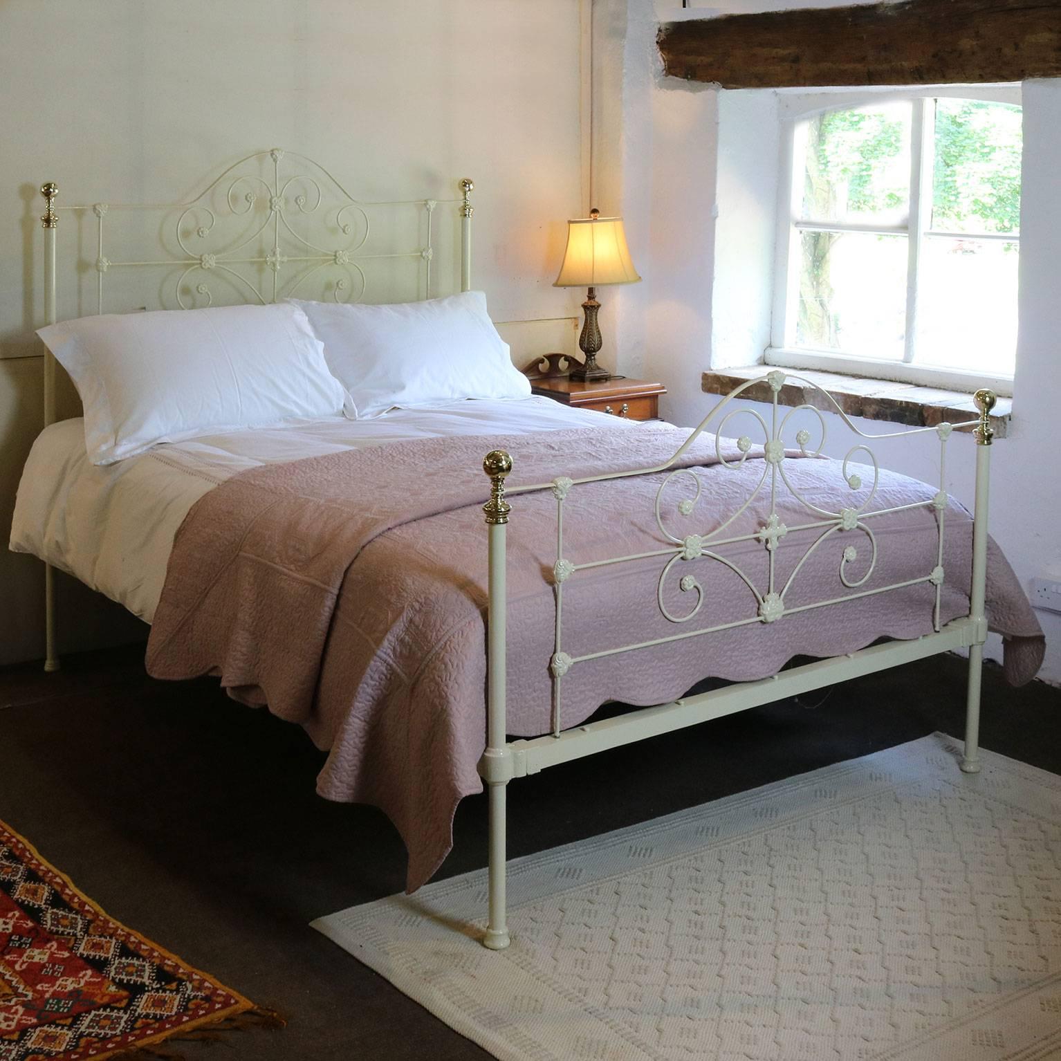 An attractive cast iron and brass bed finished in cream with scroll designs in the panels.

This bed accepts a British king-size or American queen-size (60 inches, 5ft or 150cm wide) base and mattress set.

The price is for the bed frame alone.