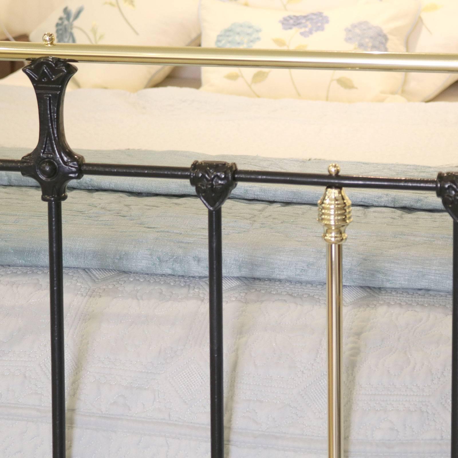 A brass and iron bed adapted from an original Victorian frame and finished in black, with ornate castings and brass straight top rail.

This bed accepts a 60 inch wide British king-size or American queen-size (5ft or 150cm) base and mattress