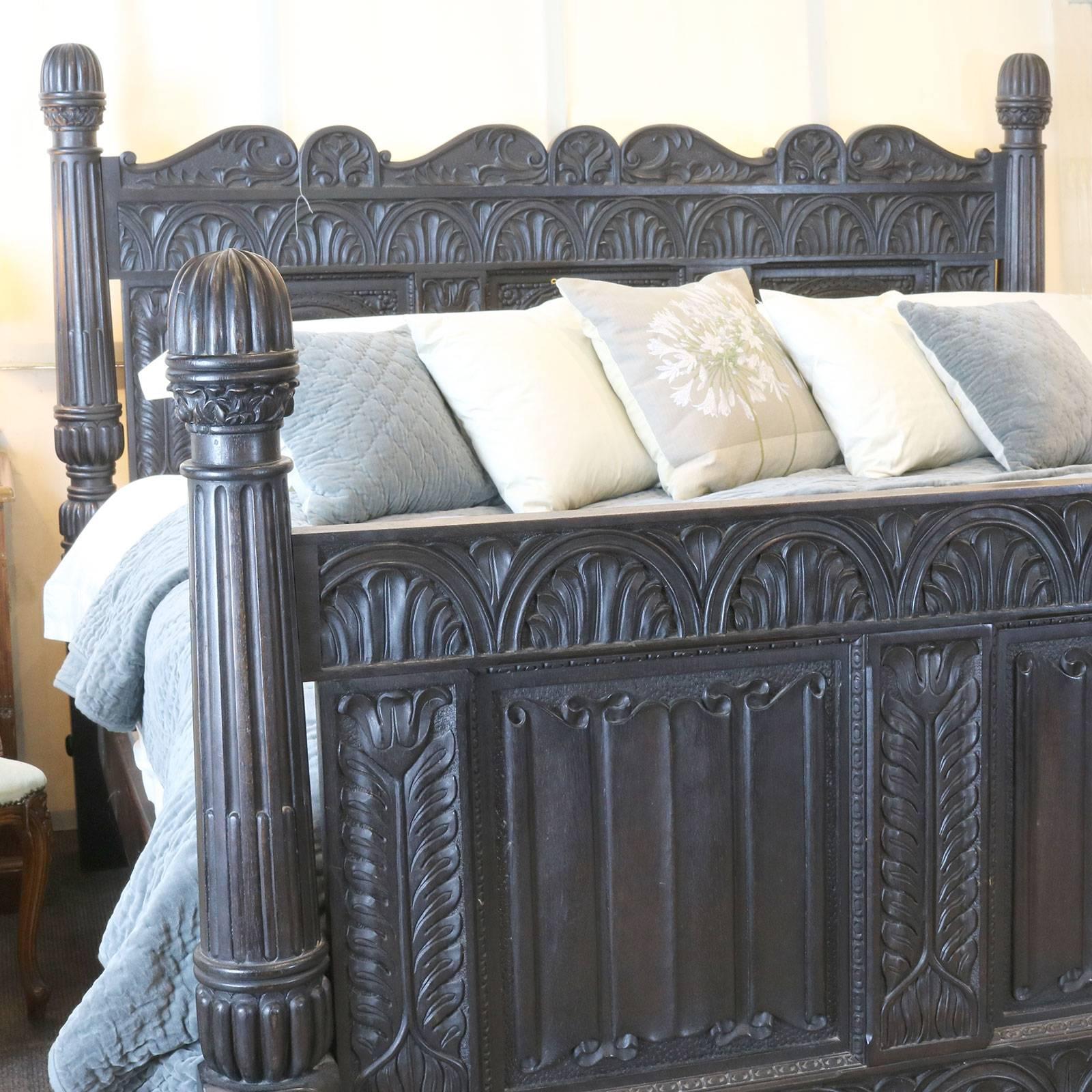 A magnificent ebonised Jacobean style bed from the mid-20th century. This superb piece is expertly carved with linen fold panels and turns posts. The back board has a tree of life in the centre flanked by two depictions of Adam and Eve eating the