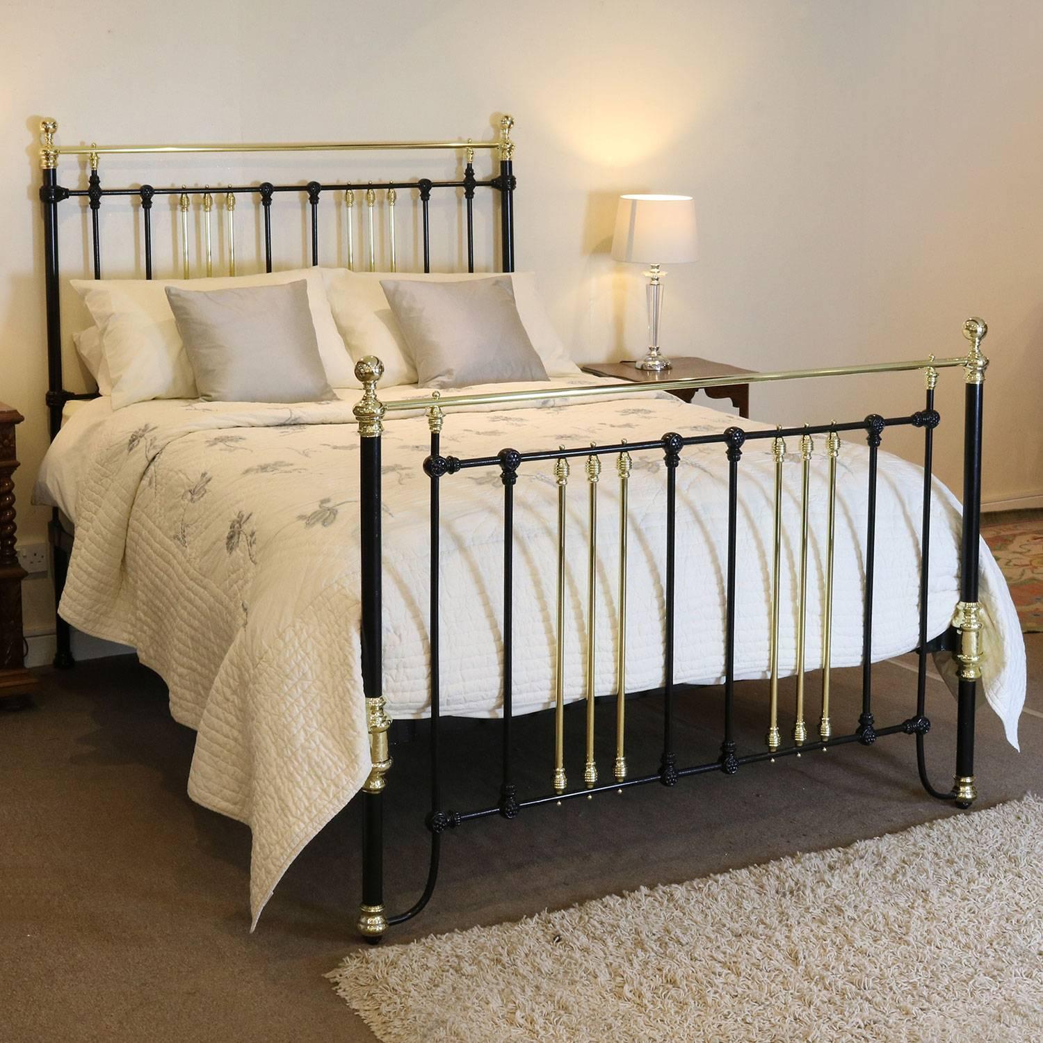 A fine brass and iron bed adapted from an original Victorian frame and finished in black with groups of three brass down bars and brass kneecaps.

This bed accepts a British king-size or American queen-size (60 inches, 5ft or 150cm) base and
