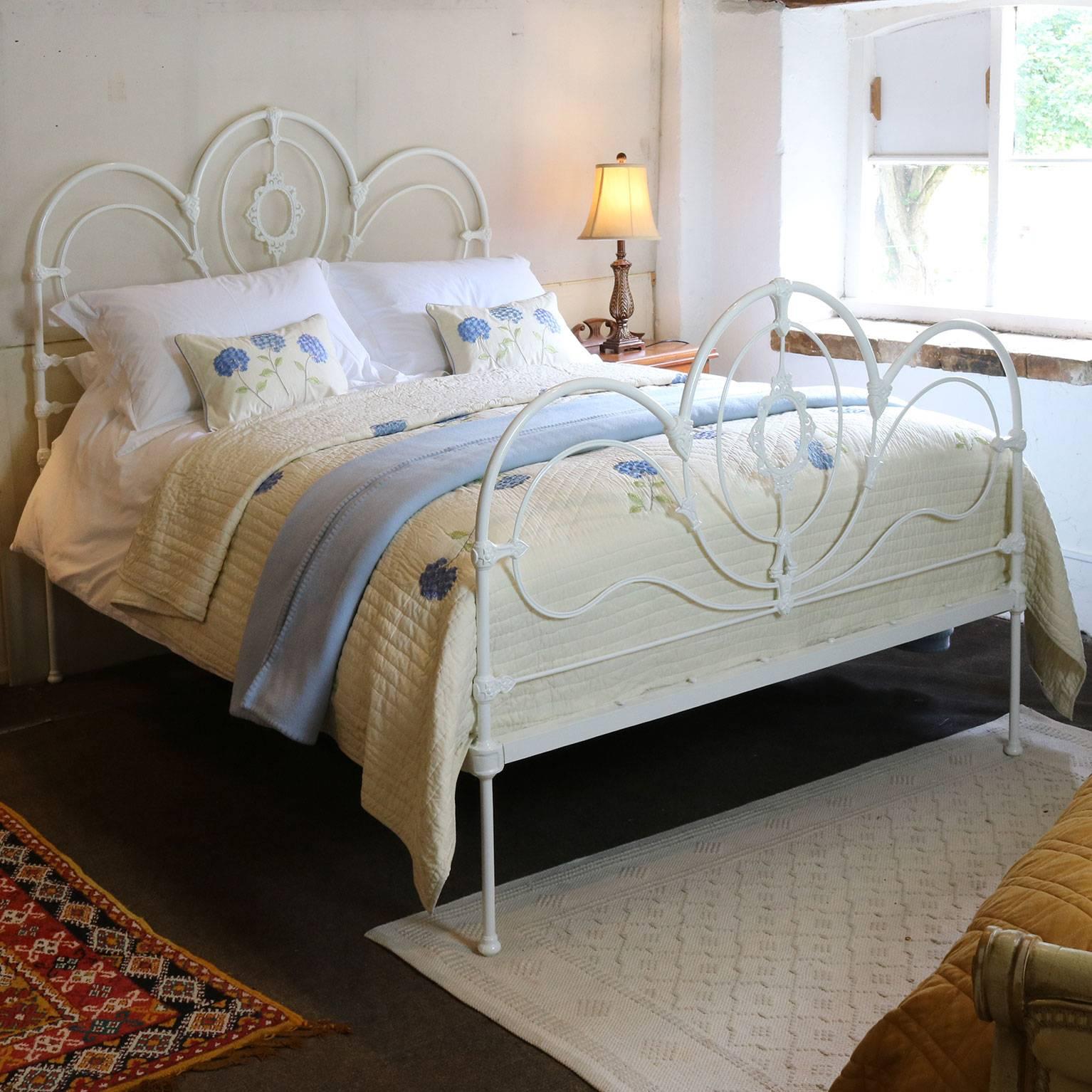 A fine example of a cast iron bedstead with decorative castings hoop design adapted and extended from an original Victorian frame.

This bed accepts a British King or American Queen (60", 5ft or 150cm wide) base and mattress set.

The price is