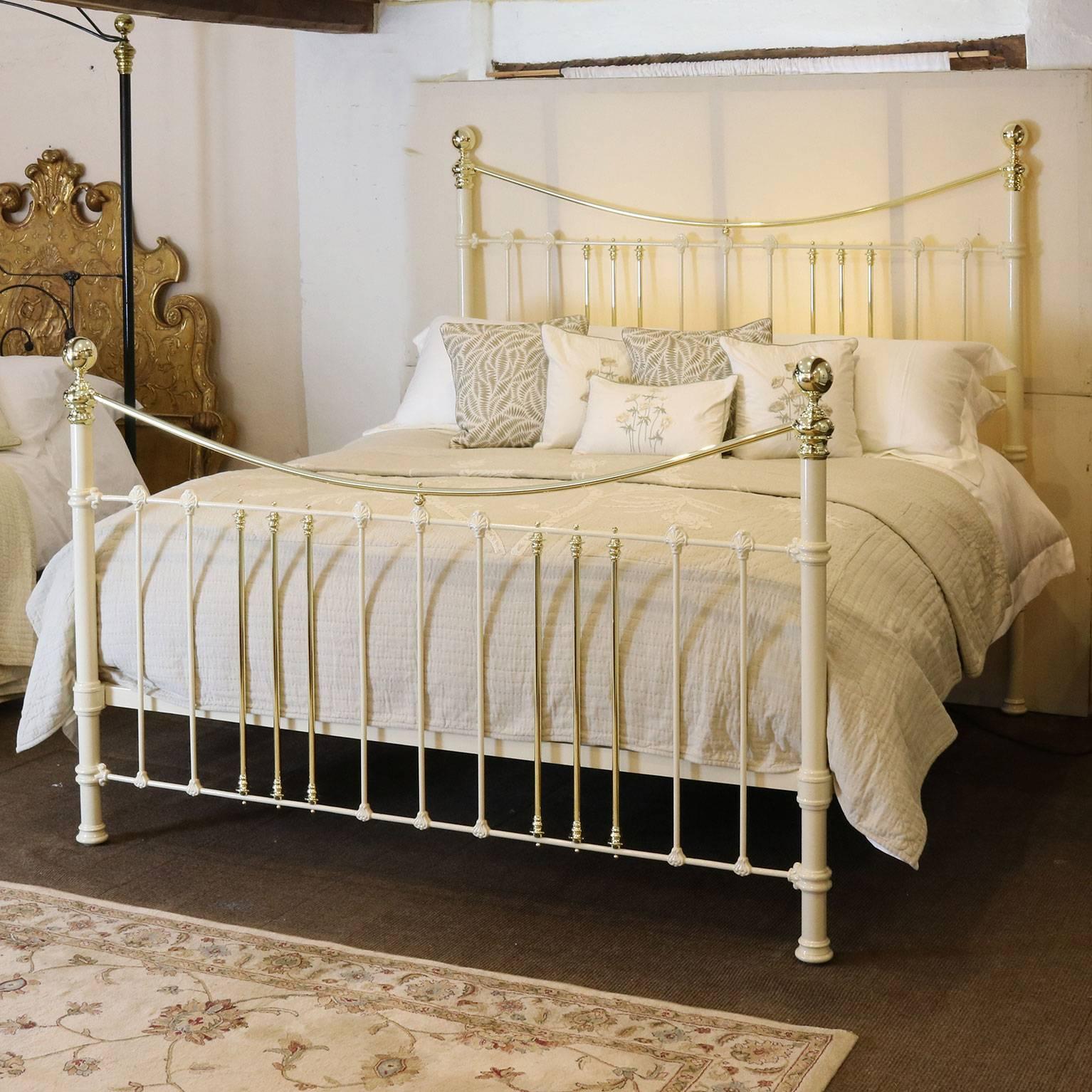 A fine example of a brass and iron bedstead with decorative castings adapted and extended from an original Victorian frame with curved brass top rail.

This bed accepts a British Super King or Californian King (72inches, 6ft or 180cm wide) base and