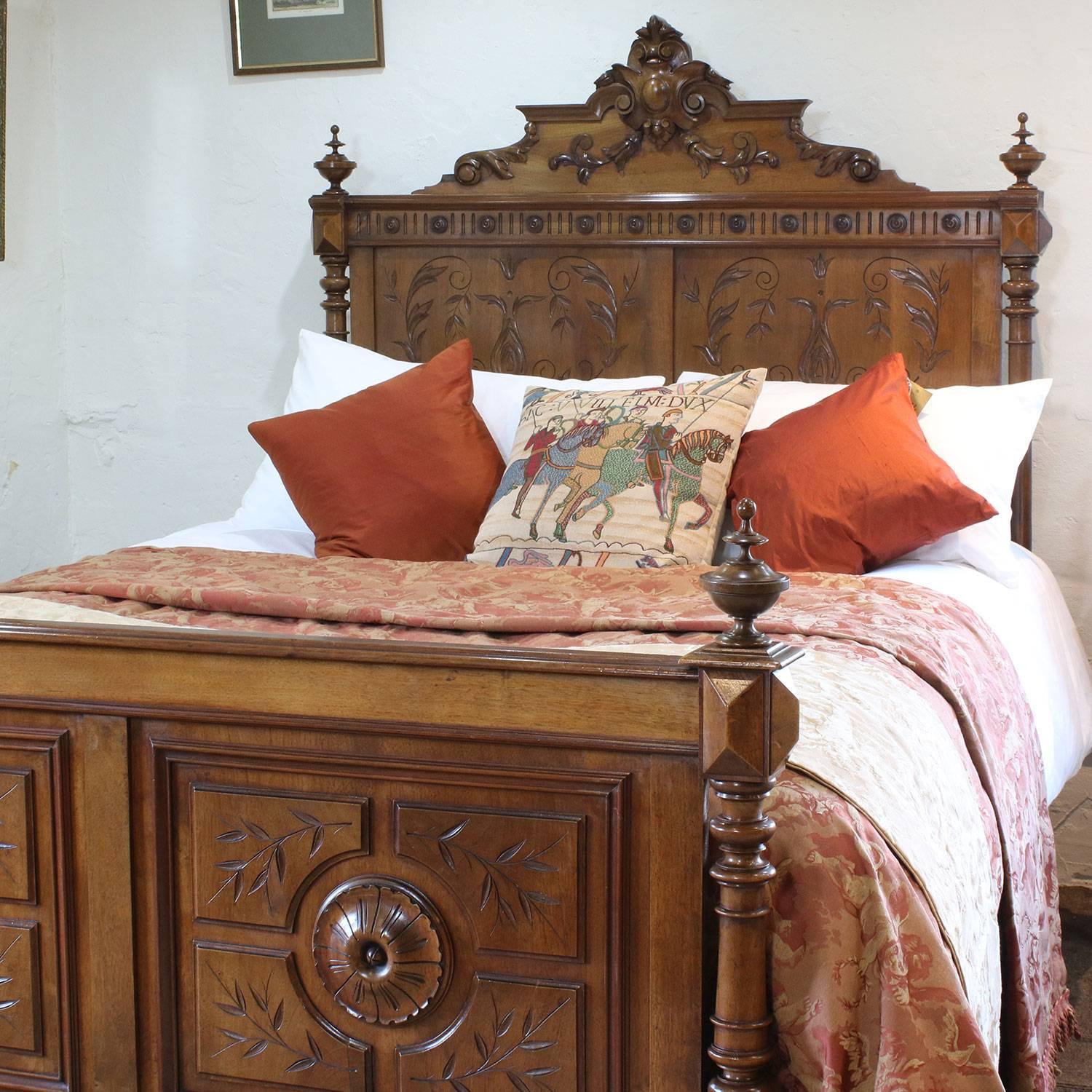 A fine carved bed with ornate head panel and foot board in walnut.

This bed accepts a British king-size or American queen-size (60 inches, 5ft or 150cm) base and mattress set.

The price is for the bed frame alone. The base, mattress, bedding and