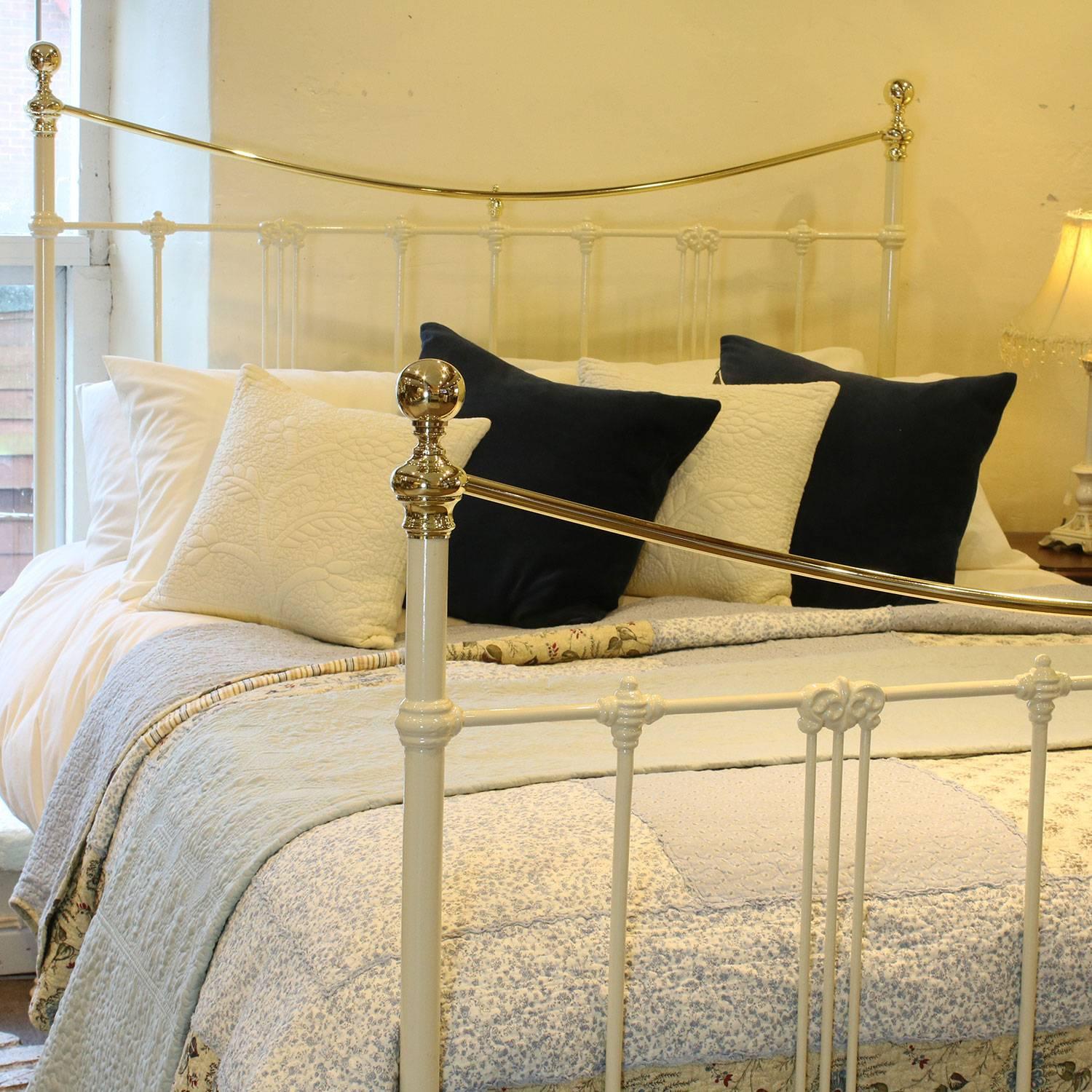 A brass and iron bed finished in cream with curved brass top rails and art nouveau style mouldings, adapted from an original Victorian frame, circa 1895.

This bed accepts a British king-size or US queen size (5ft, 60 in or 150 cm wide) base and