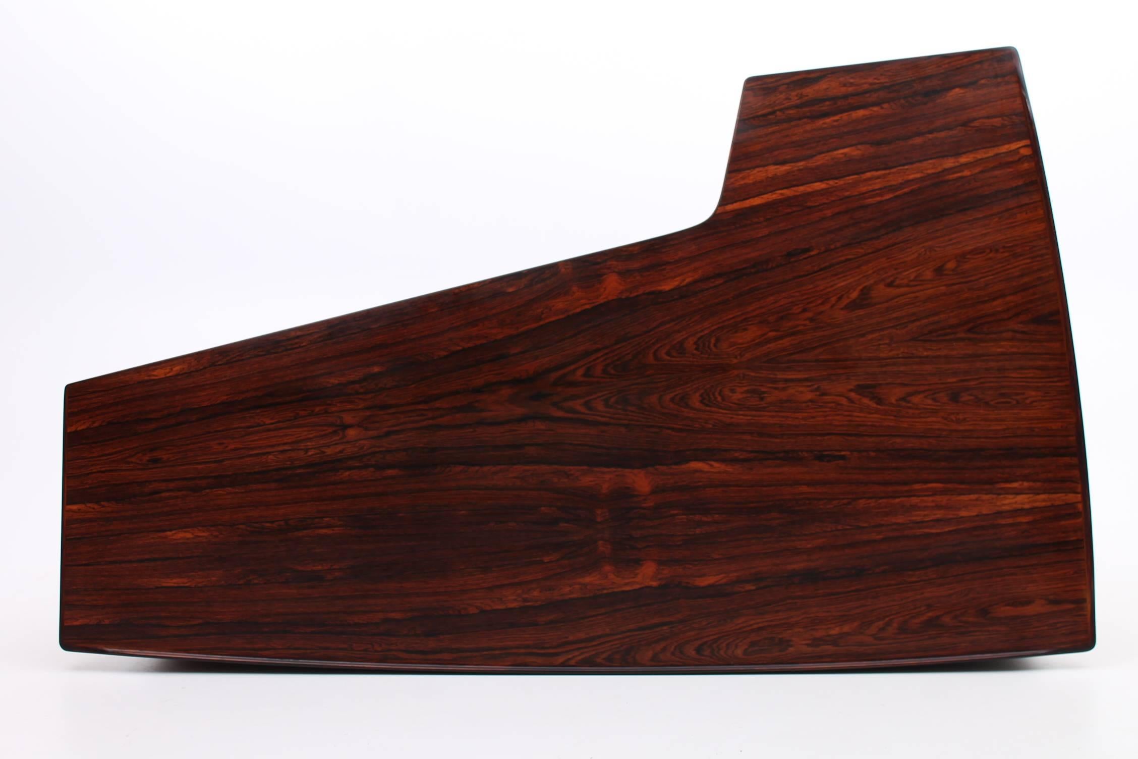 Amazing rosewood desk by Peter Lovig Nielsen for Hedendsted Møbelfabrik circa 1956. The L-shaped design makes the desk an architecturally dramatic piece while the rosewood gives it an elegant finish. There is a small lip around the desk so you don’t