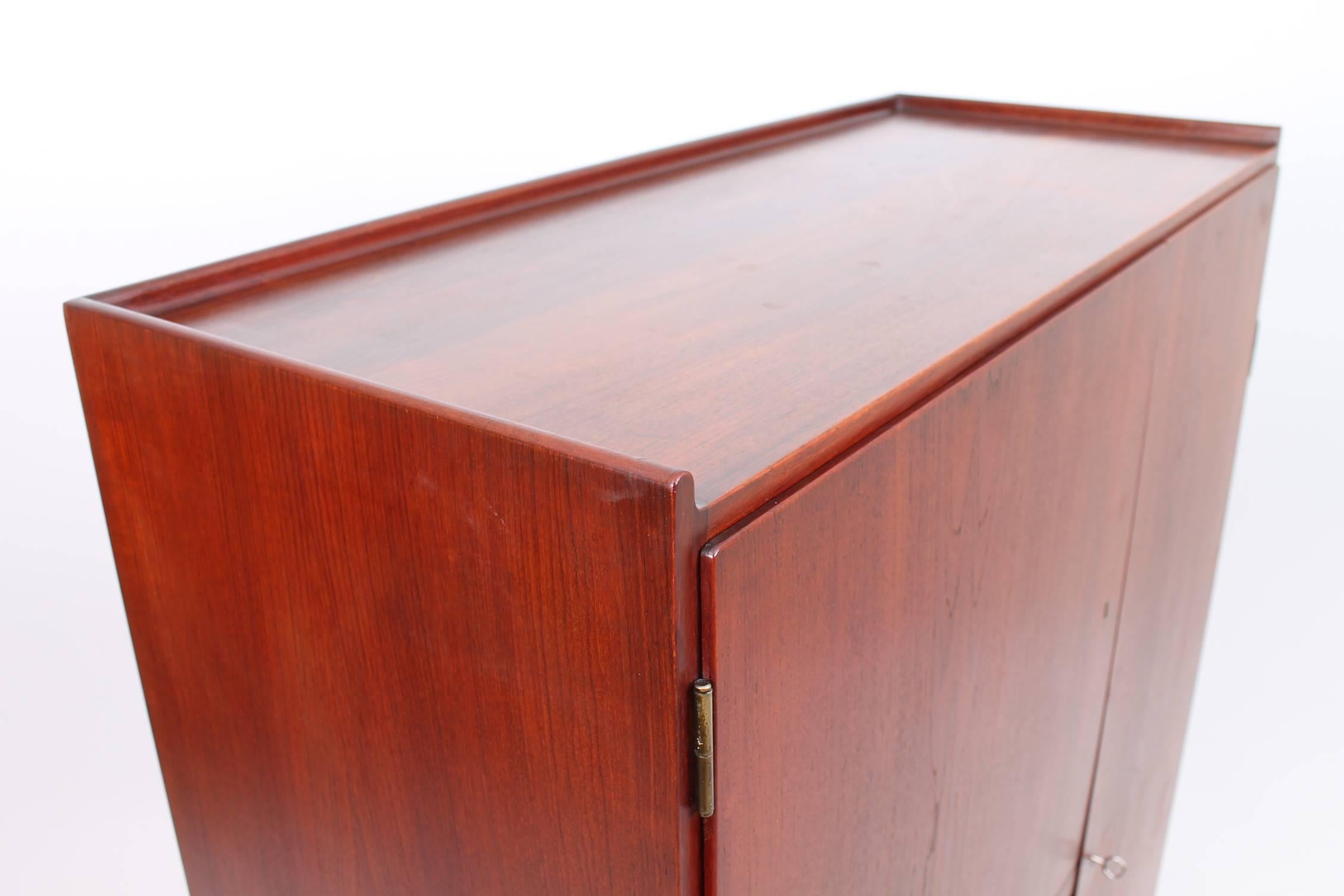 Beautiful, rare cabinet designed by Finn Juhl for Bovirke, circa the 1950s. The doors of the cabinet are made of teak and open to reveal adjustable and customizable shelving and drawers. The finished and stained interior of this piece is just as