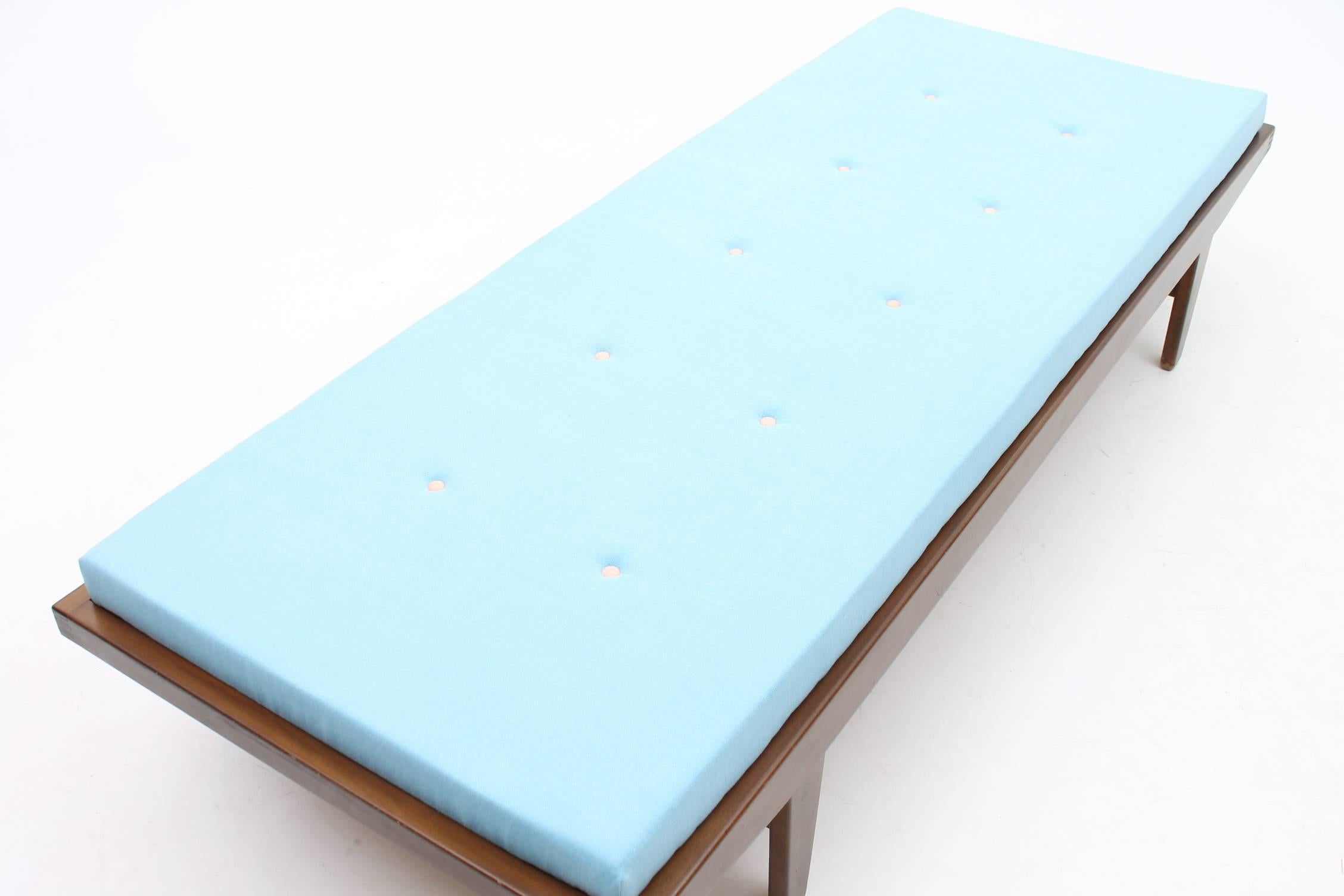 Beautiful daybed designed by Poul Volther for Illums Bolighus. The cushion is has brand new foam and new light blue upholstery with natural leather buttons. The oak frame is sleek and contrasts with the bright foam cushion. The daybed is in