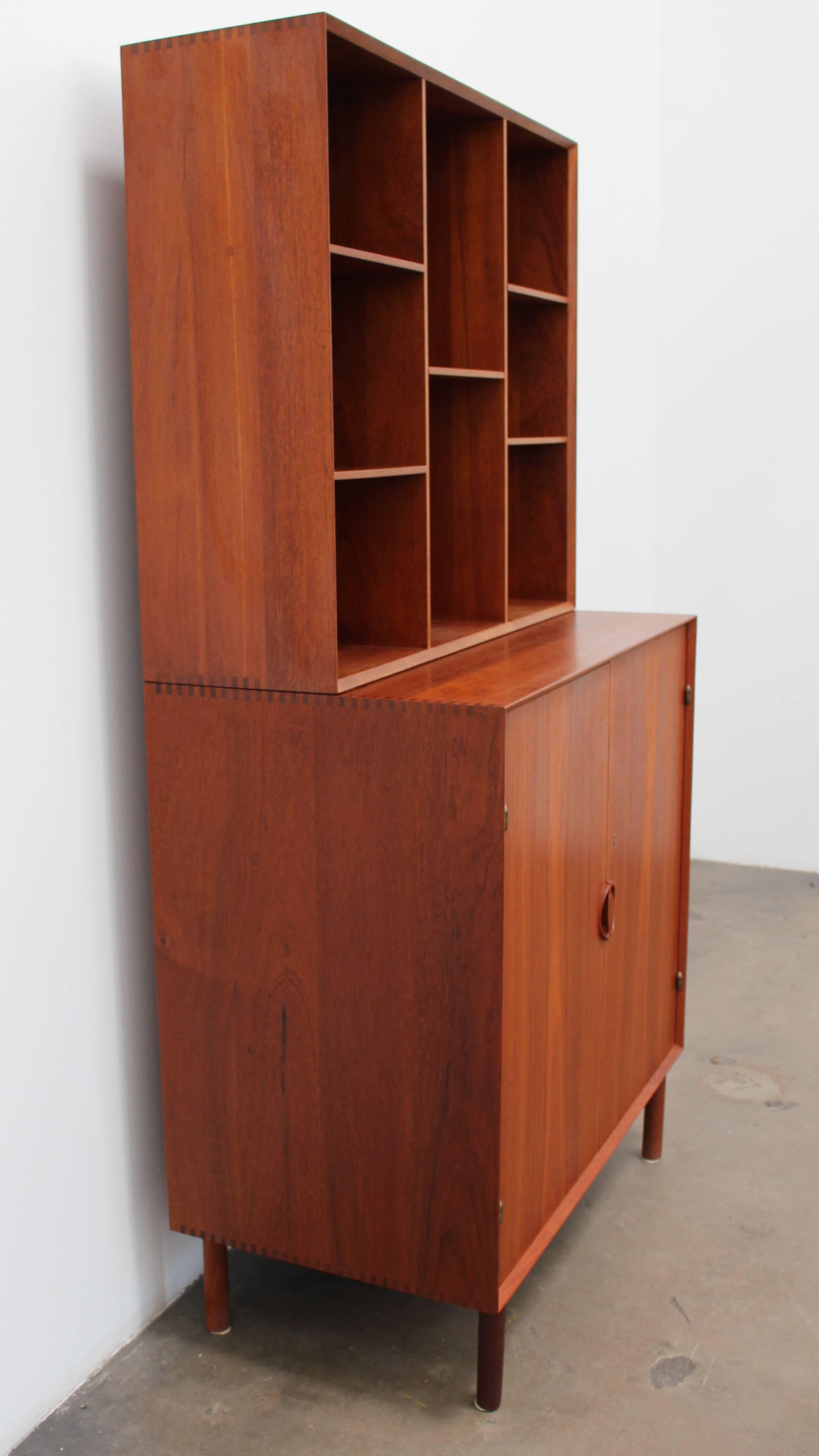 Beautiful cabinet designed by Hvidt + Mølgaard for Søborg Møbelfabrik circa the 1960s. The entire piece is constructed of solid teak. The listing comes with the shelf that can be stacked on top, or can be complete on its own (or maybe hung on the