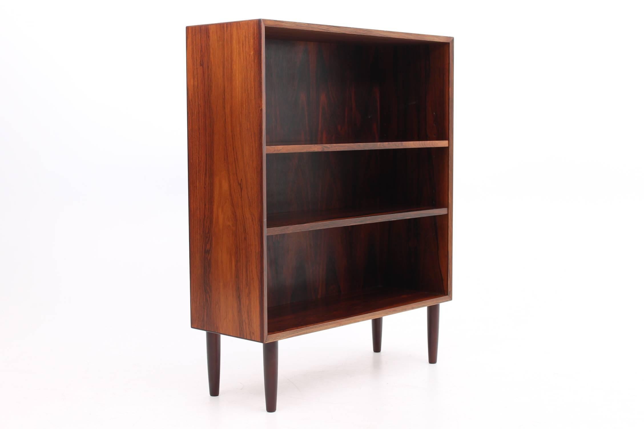Gorgeous bookcase made of rosewood designed by Lyby Møbler. This bookcase features two adjustable shelves. The bookcase is very minimal in design and is in very good condition.
  