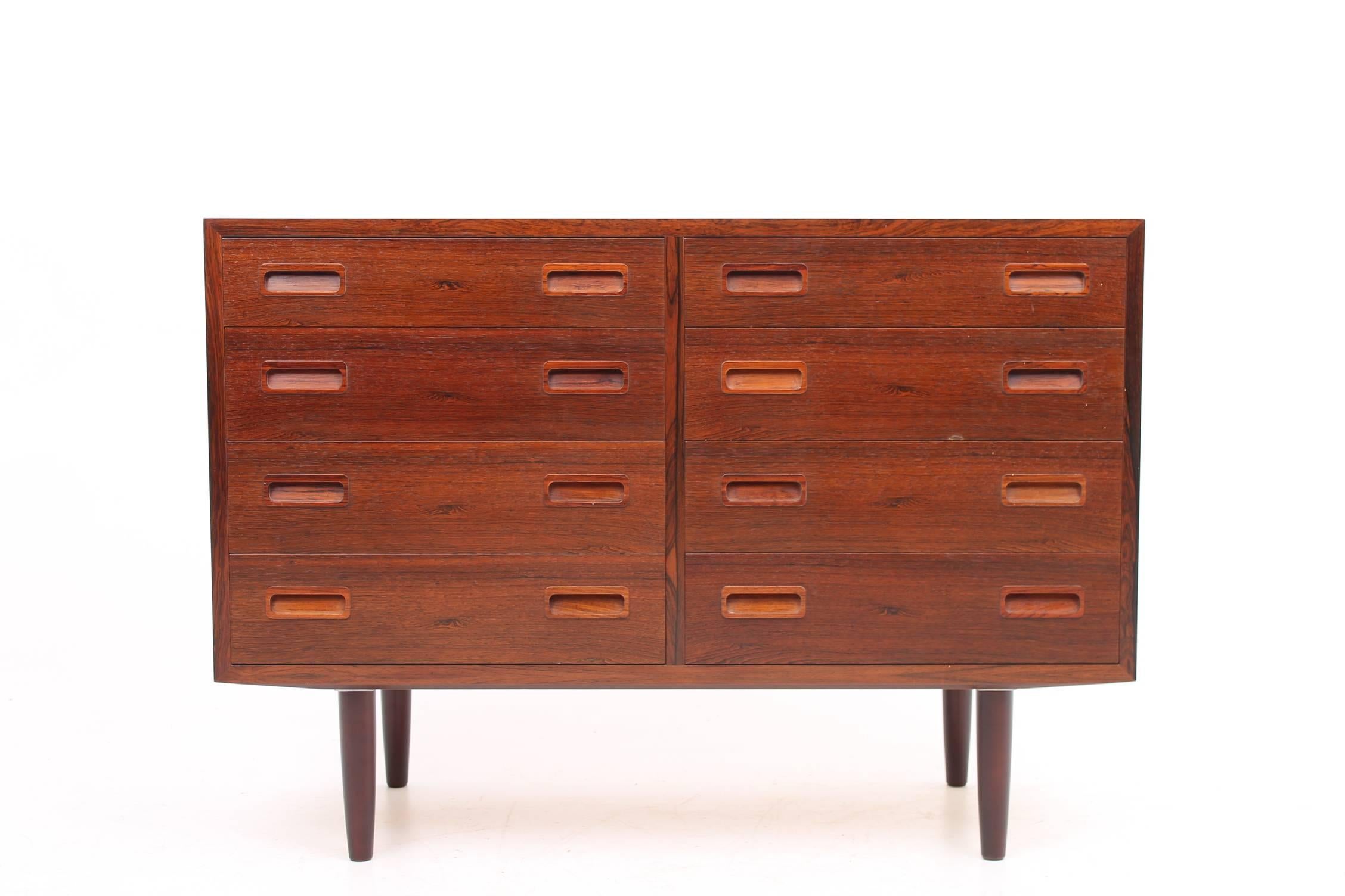 Beautiful chest of drawers made of rosewood designed by Poul Hundevad. This gorgeous storage has storage on both sides for a total of ten drawers. All of the handles are handmade of rosewood. The wood on this chest of gorgeous and has a thick,