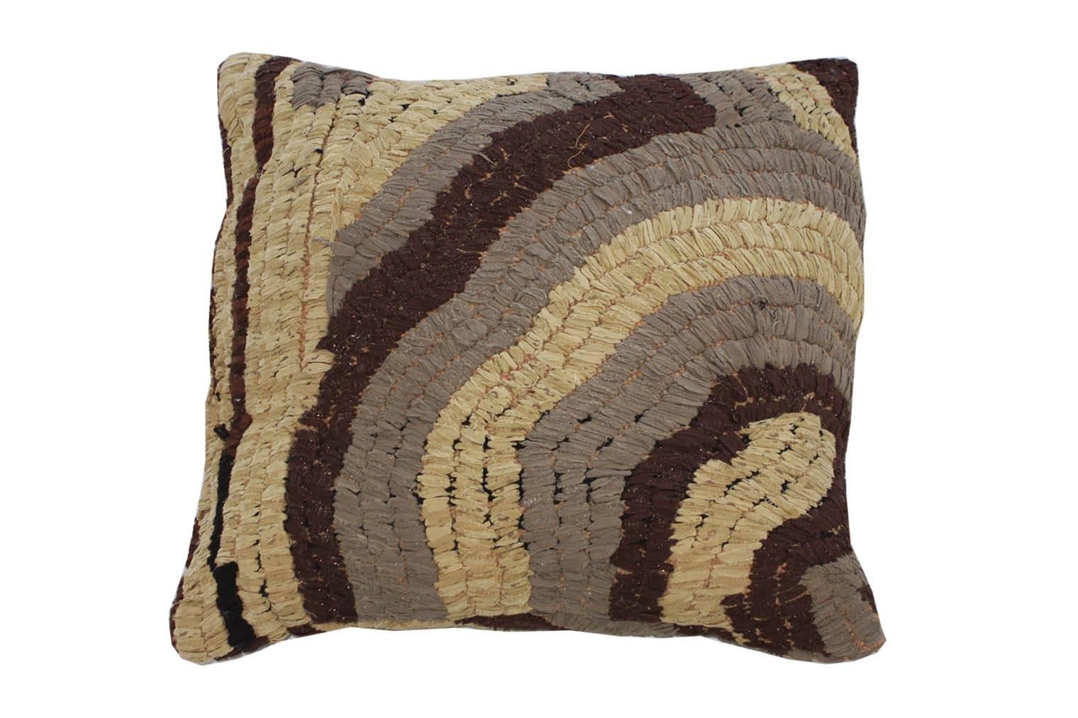 Floor pillow made of vintage Moroccan textile rug. 
This pillow is tan, taupe, brown and metallic silver.
Measures: 28" L x 27" W.