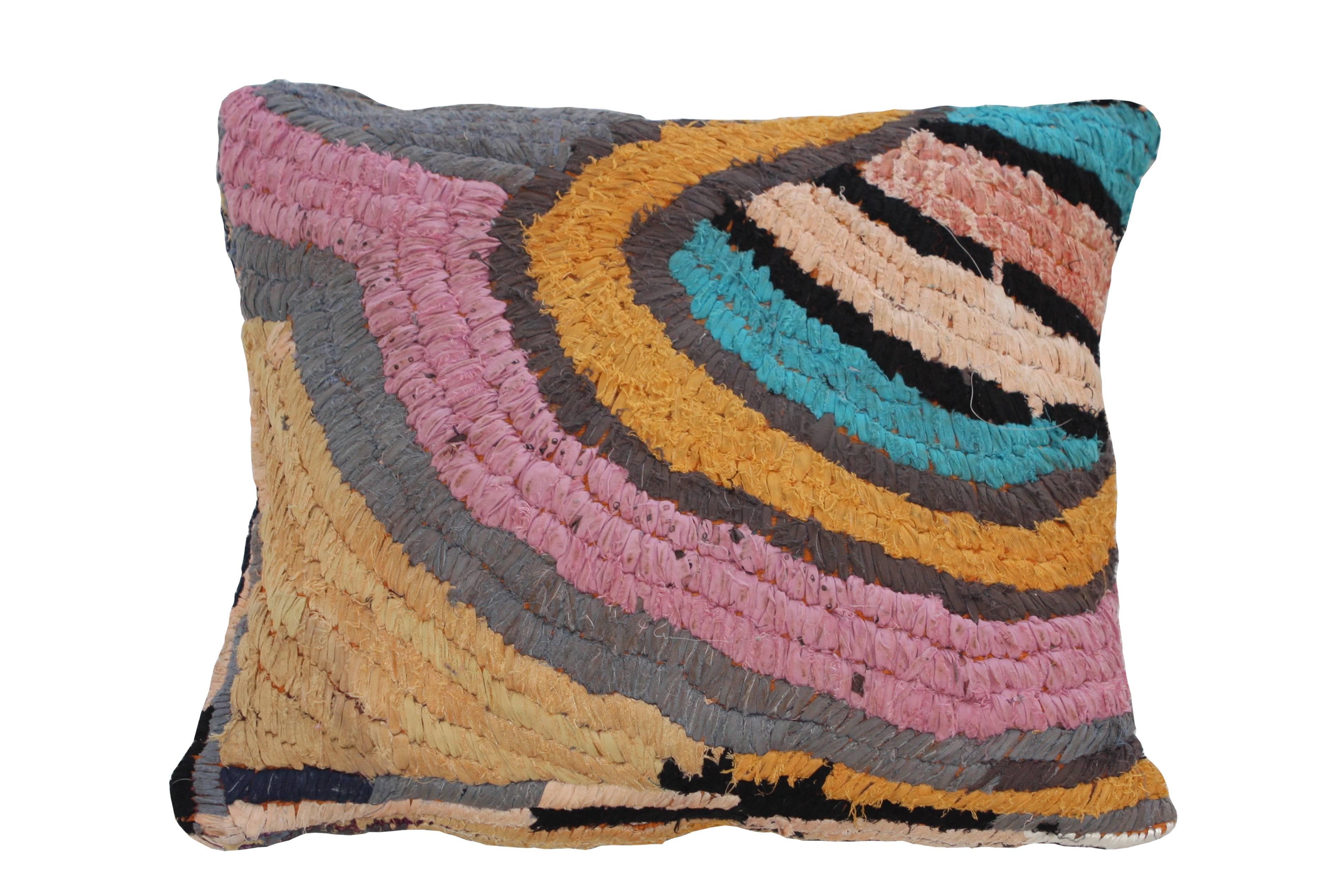 Floor pillow made with vintage Moroccan textile rug.
This pillow is orange and grey with accents in black, pink, aqua, and brown.
Measures: 28" L x 26" W.